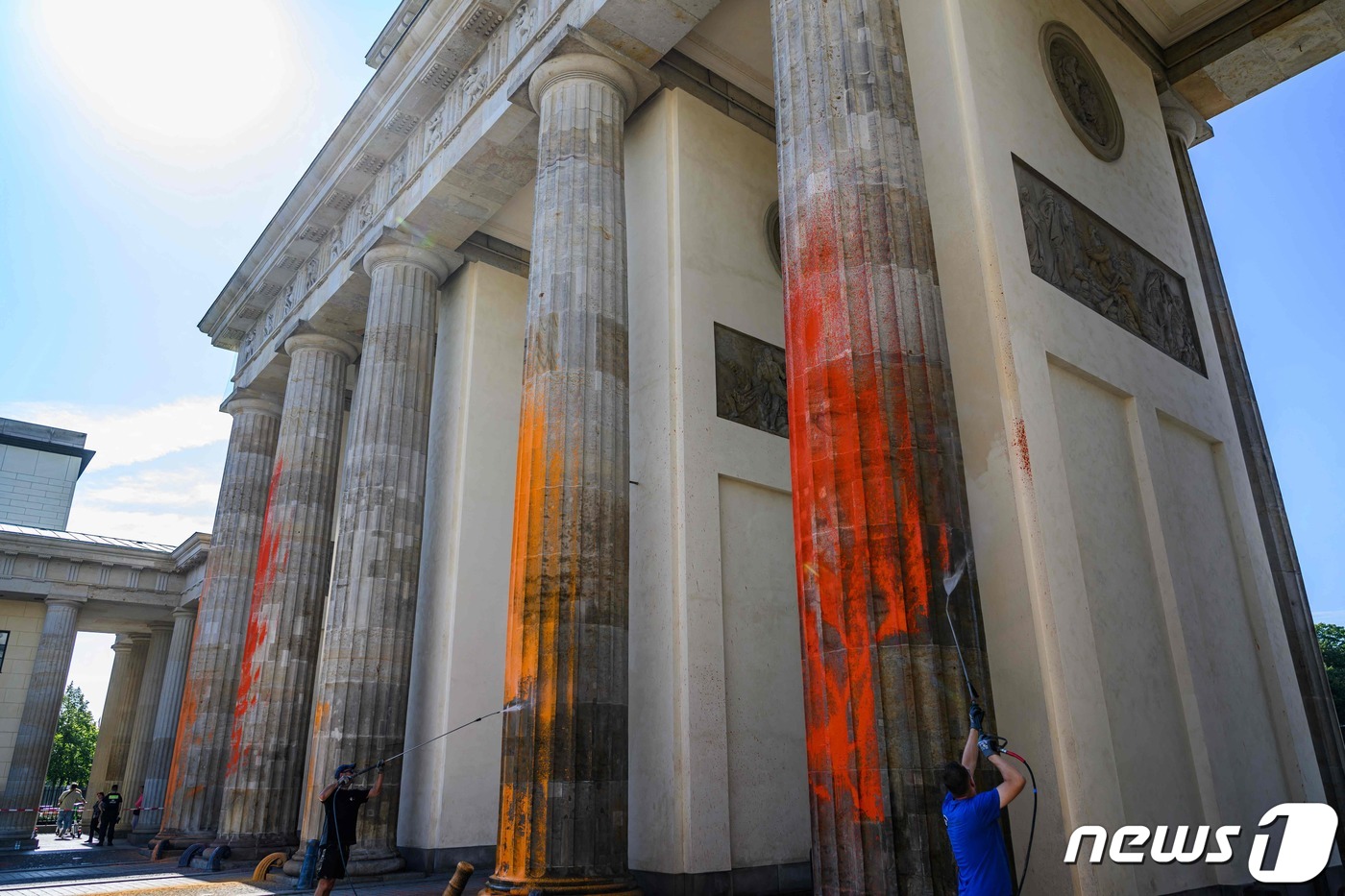(베를린 AFP=뉴스1) 장성희 기자 = 17일(현지시간) 독일 베를린 브란덴부르크 문에 칠해진 페인트를 작업자들이 닦아내고 있다. 페인트는 기후 운동 단체인 '마지막 세대'가 뿌 …