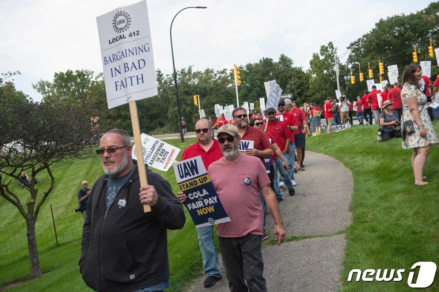 본문 이미지 - 지난 20일 미국 미시간주 오번 힐스에 있는 스텔란티스 본사 앞에서 전미자동차노동조합 조합원들이 피켓 시위를 벌이고 있다. 2023.09.20/ ⓒ AFP=뉴스1 ⓒ News1 장성희 기자