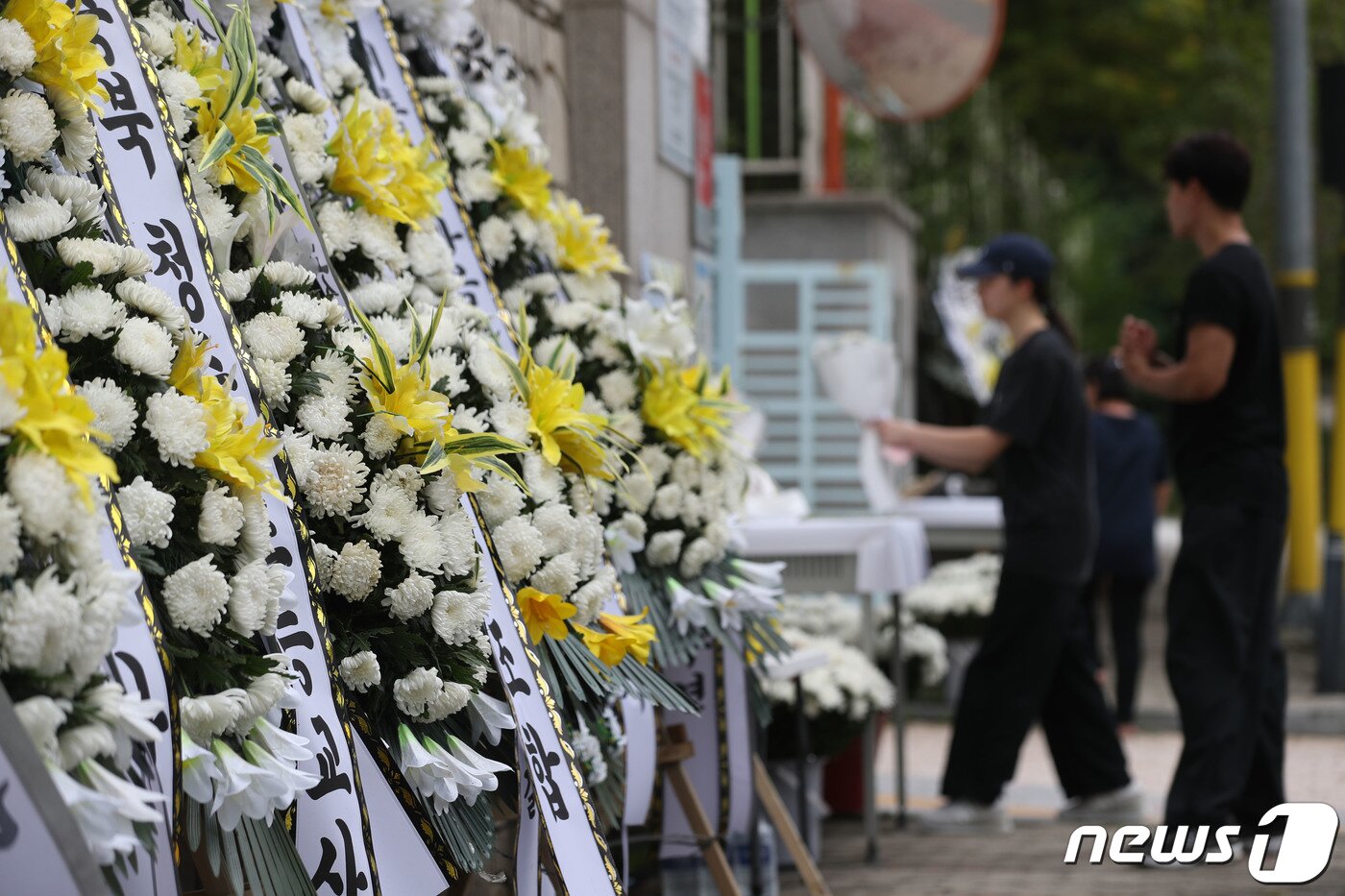 본문 이미지 - 4일 오후 경기 용인시의 한 고등학교 앞에 학부모로부터 피소된 뒤 극단선택으로 숨진 60대 체육교사를 추모하는 근조화환이 놓여 있다. 2023.9.4/뉴스1 ⓒ News1 김영운 기자