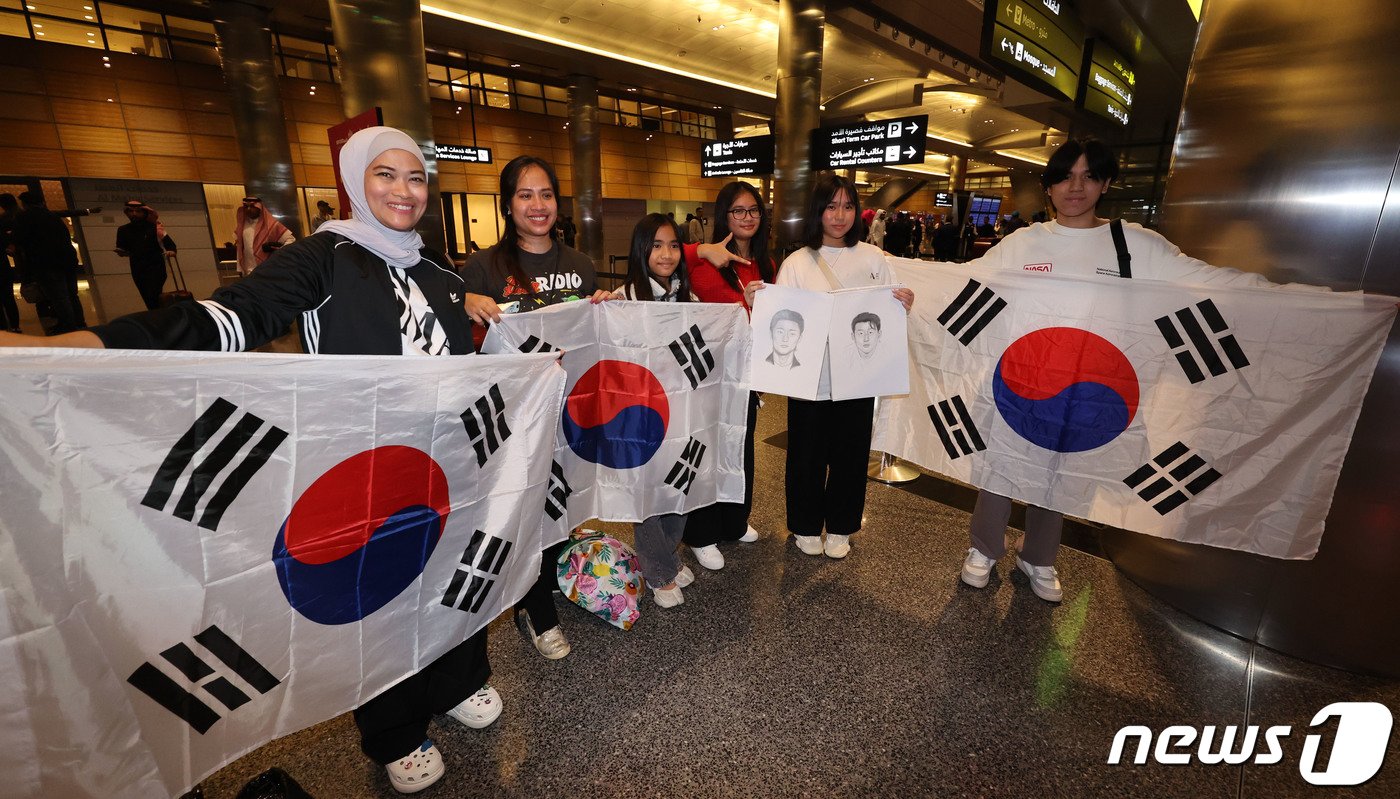 본문 이미지 - 2023 아시아축구연맹(AFC) 카타르 아시안컵에 출전하는 대한민국 축구대표팀이 10일(현지시간) 카타르 도하 하마드 국제공항을 통해 입국한 가운데 인도네시아와 필리핀 축구팬들이 태극기를 들고 기념촬영을 하고 있다. 위르겐 클린스만 감독이 이끄는 대표팀은 오는 15일 E조 조별리그 첫 경기인 바레인전을 시작으로 20일 요르단, 25일 말레이시아와 경기를 치른다. 2024.1.11/뉴스1 ⓒ News1 김성진 기자