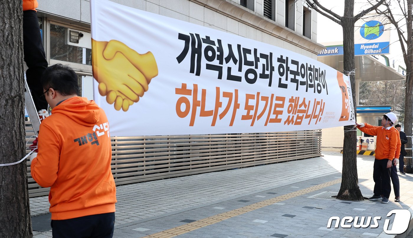 이준석 개혁신당 대표와 김용남 정책위의장이 26일 오후 서울 여의도 국회앞 가로수에 당의 첫 현수막을 설치하고 있다. 2024.1.26/뉴스1 ⓒ News1 구윤성 기자