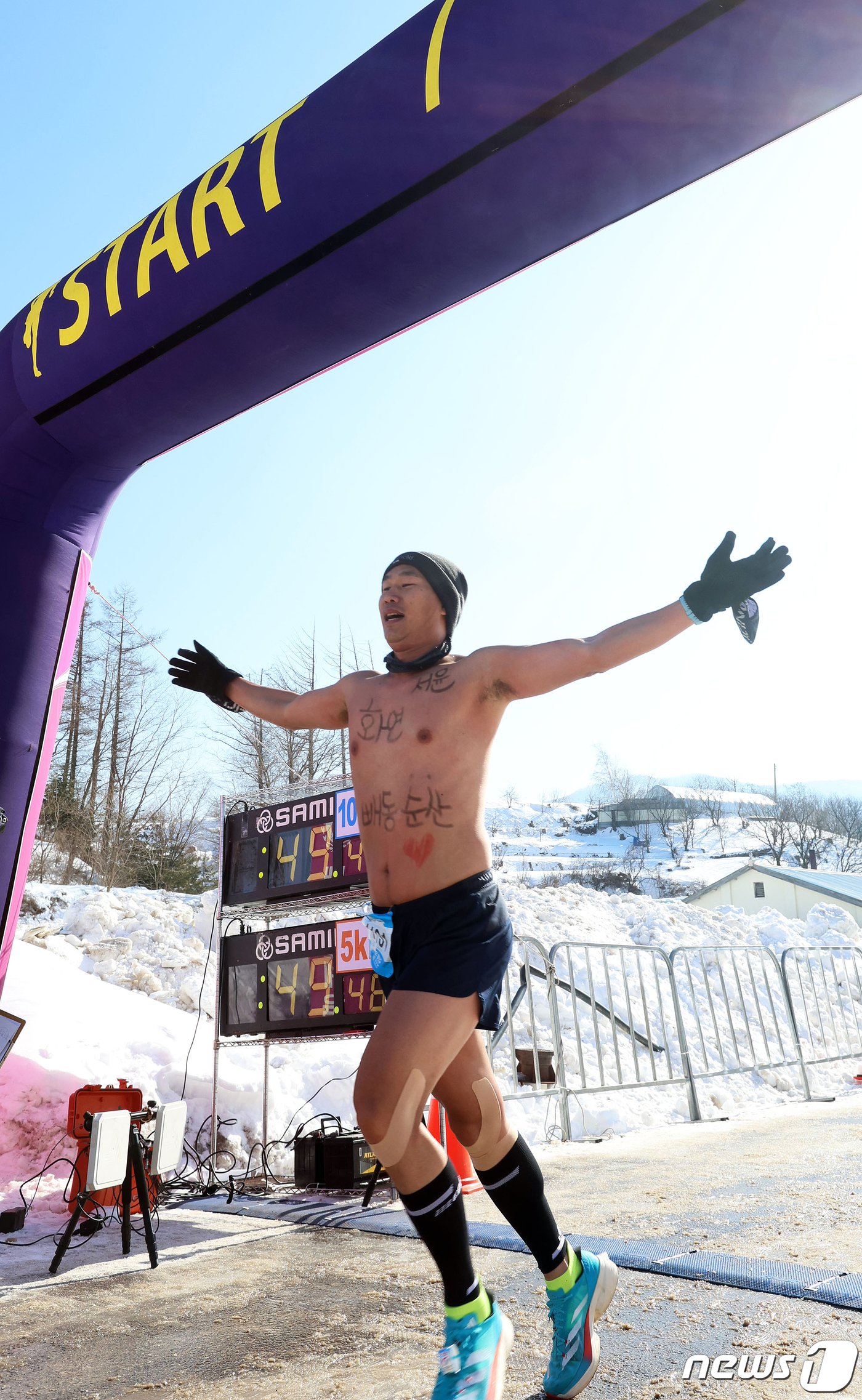 28일 오전 영하 10도의 추위속에 강원 평창군 대관령 눈꽃축제장 일원에서 열린 2024 평창 대관령 알몸 마라톤 대회 참가자가 완주를 마치고 피니쉬라인에 골인하고 있다. 코로나19로 3년만에 재개된 이번 대회에는 일반&#40;10km, 5km&#41;, 매니아&#40;10km, 5km&#41;, 커플런&#40;남여2인1조&#41; 부문 등에 미국, 호주 등 6개국 외국인 40여명과 10대부터 여든이 넘은 할아버지까지 약 500여명의 참가자들이 강추위를 즐기며 달리기를 즐겼다. &#40;평창군 제공&#41; 2024.1.28/뉴스1