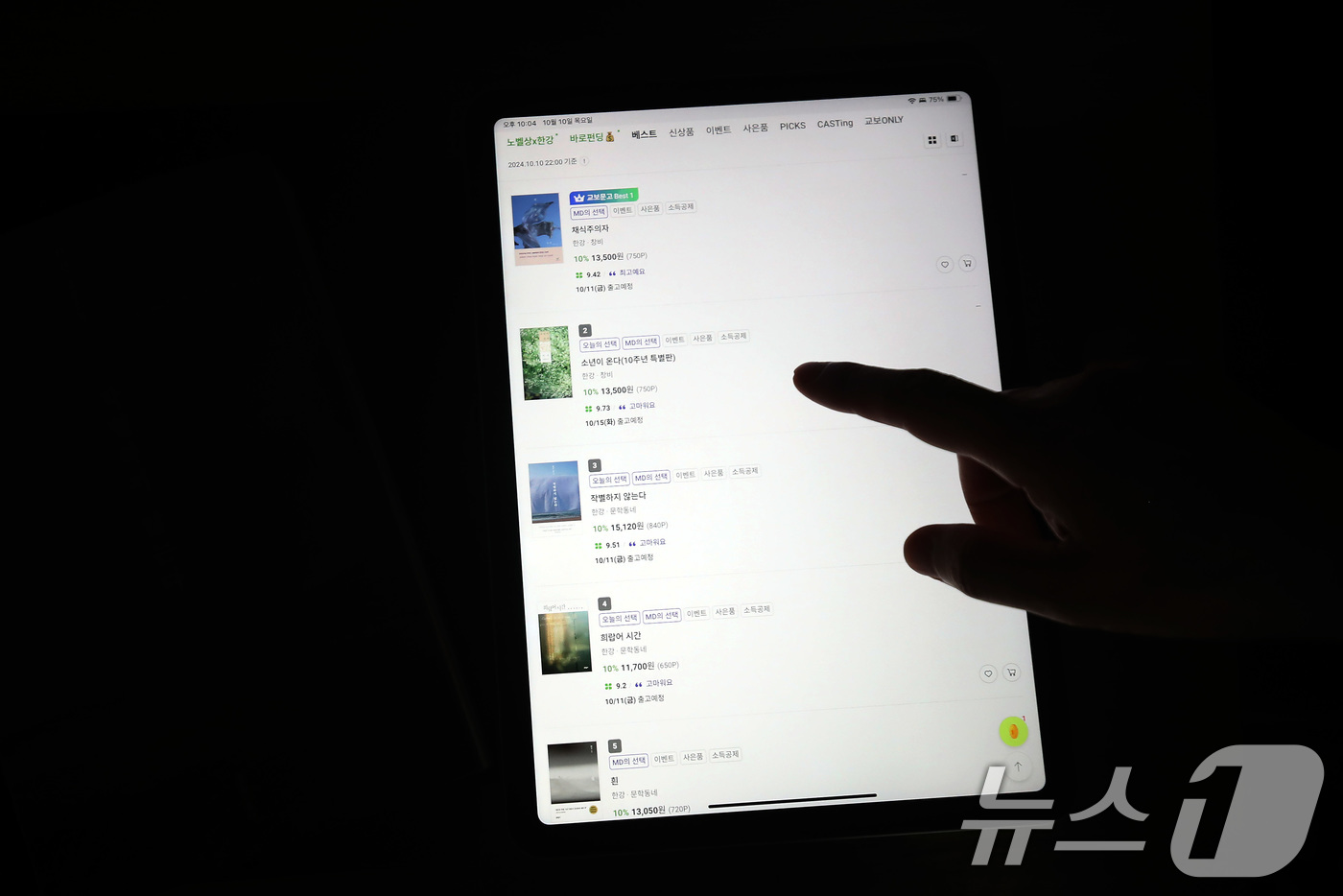 (대구=뉴스1) 공정식 기자 = 한강 작가의 노벨문학상 수상 소식이 전해진 10일 오후 대구의 한 시민이 태블릿PC로 교보문고 앱을 통해 실시간 베스트셀러 순위를 살펴보고 있다.교 …