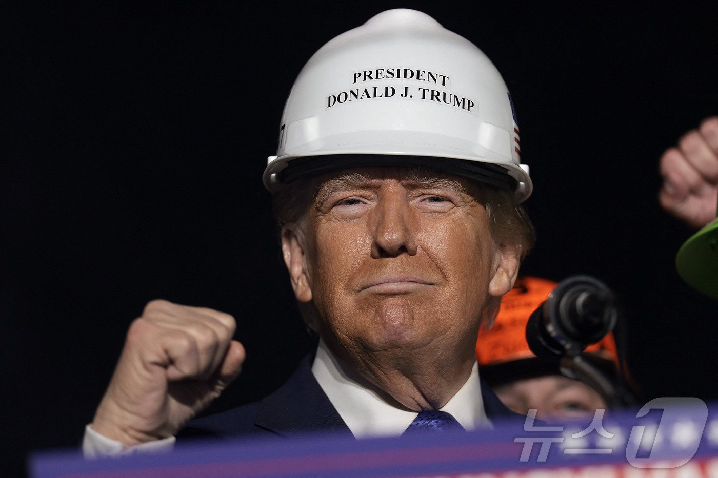 본문 이미지 - 미국 공화당 대선 후보인 도널드 트럼프 전 대통령이 지난달 19일(현지시간) 경합주인 펜실베이니아주 래트로브에서 열린 선거 집회 중 철강 노동자가 준 안전모를 쓰고 주먹을 불끈 쥐고 있다. 2024.10.20 ⓒ AFP=뉴스1 ⓒ News1 