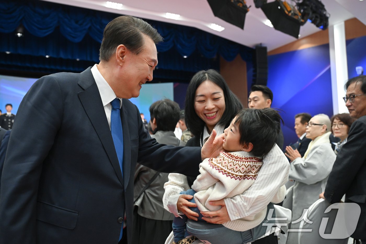 본문 이미지 - 윤석열 대통령이 21일 서울 서대문구 경찰청 참수리홀에서 열린 79주년 경찰의 날 기념식을 마치고 故 유재국 경위의 유가족과 인사를 나누고 있다. (대통령실 제공) 2024.10.21/뉴스1 ⓒ News1 송원영 기자