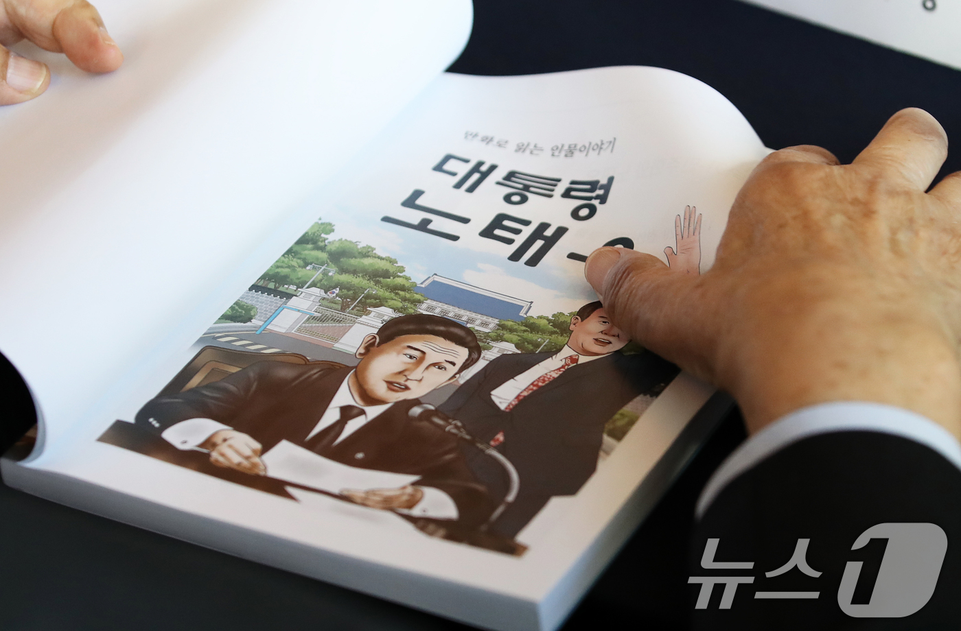 (서울=뉴스1) 오대일 기자 = 25일 서울 중구 웨스틴조선호텔에서 열린 '만화로 읽는 인물이야기 대통령 노태우' 출판 축하연에서 한 참석자가 책을 살펴보고 있다.노태우 전 대통령 …