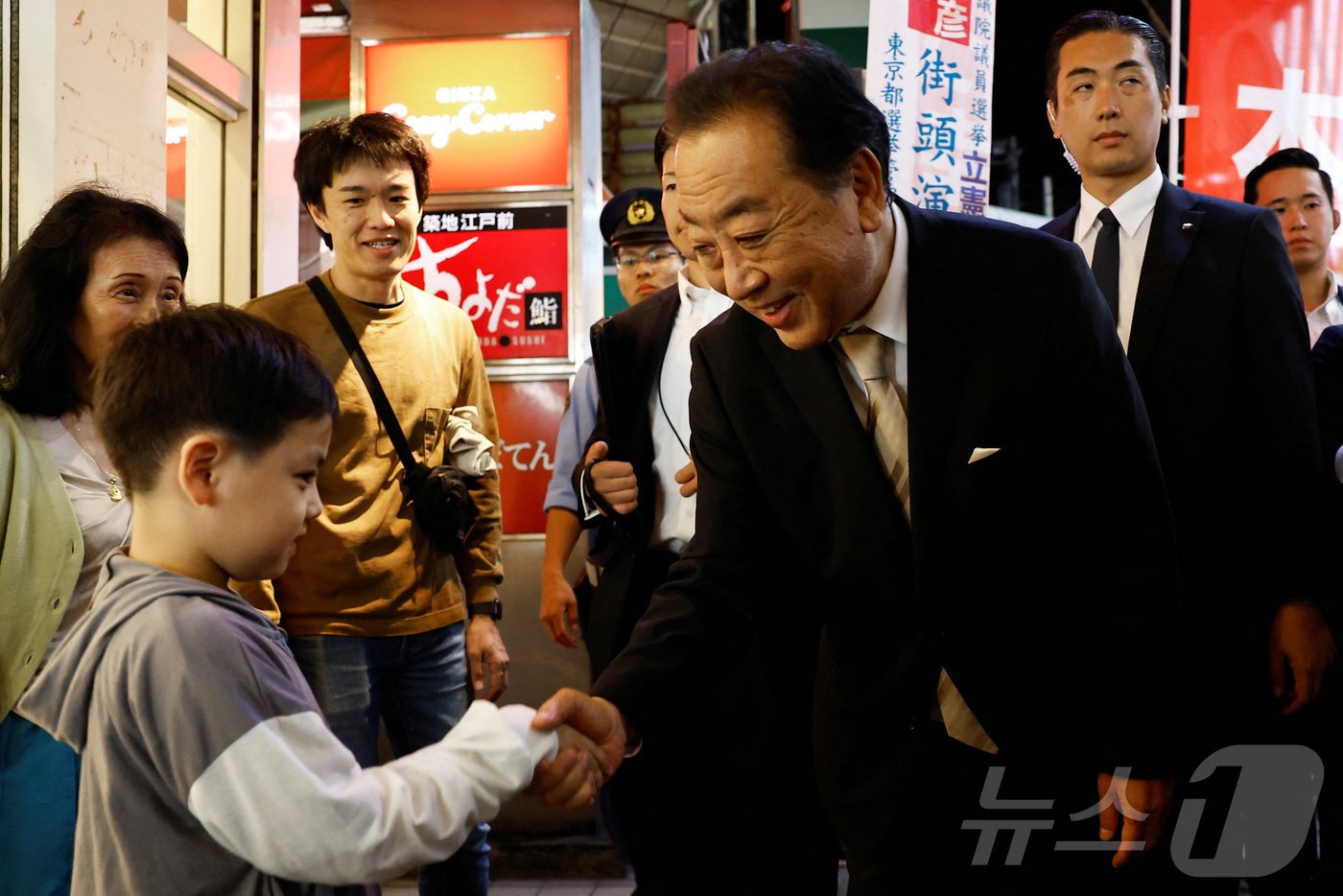 본문 이미지 - 26일 일본 도쿄에서 노다 요시히코 입헌민주당 대표가 중의원 선거 하루 전 거리 유세 중 어린이와 악수하고 있다. 2024.10.26/ ⓒ 로이터=뉴스1 ⓒ News1 권진영 기자