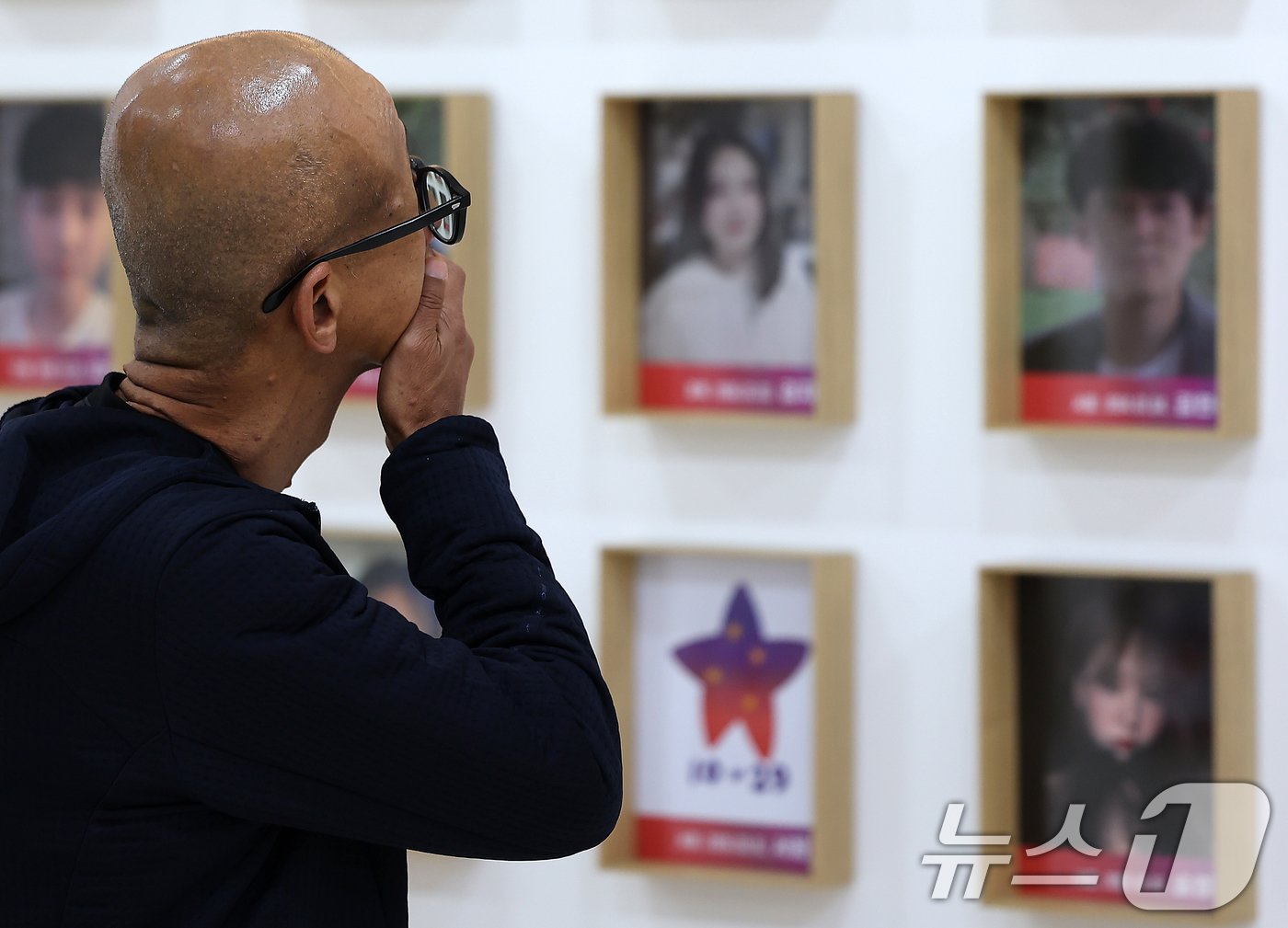 본문 이미지 - 159명의 희생자가 발생한 10·29 이태원 참사 2주기인 29일 오전 서울 중구 을지로 1가 부림빌딩 내 10·29 이태원 참사 기억·소통공간 '별들의 집'을 찾은 한 시민이 영정을 바라보고 있다. 2024.10.29/뉴스1 ⓒ News1 김진환 기자