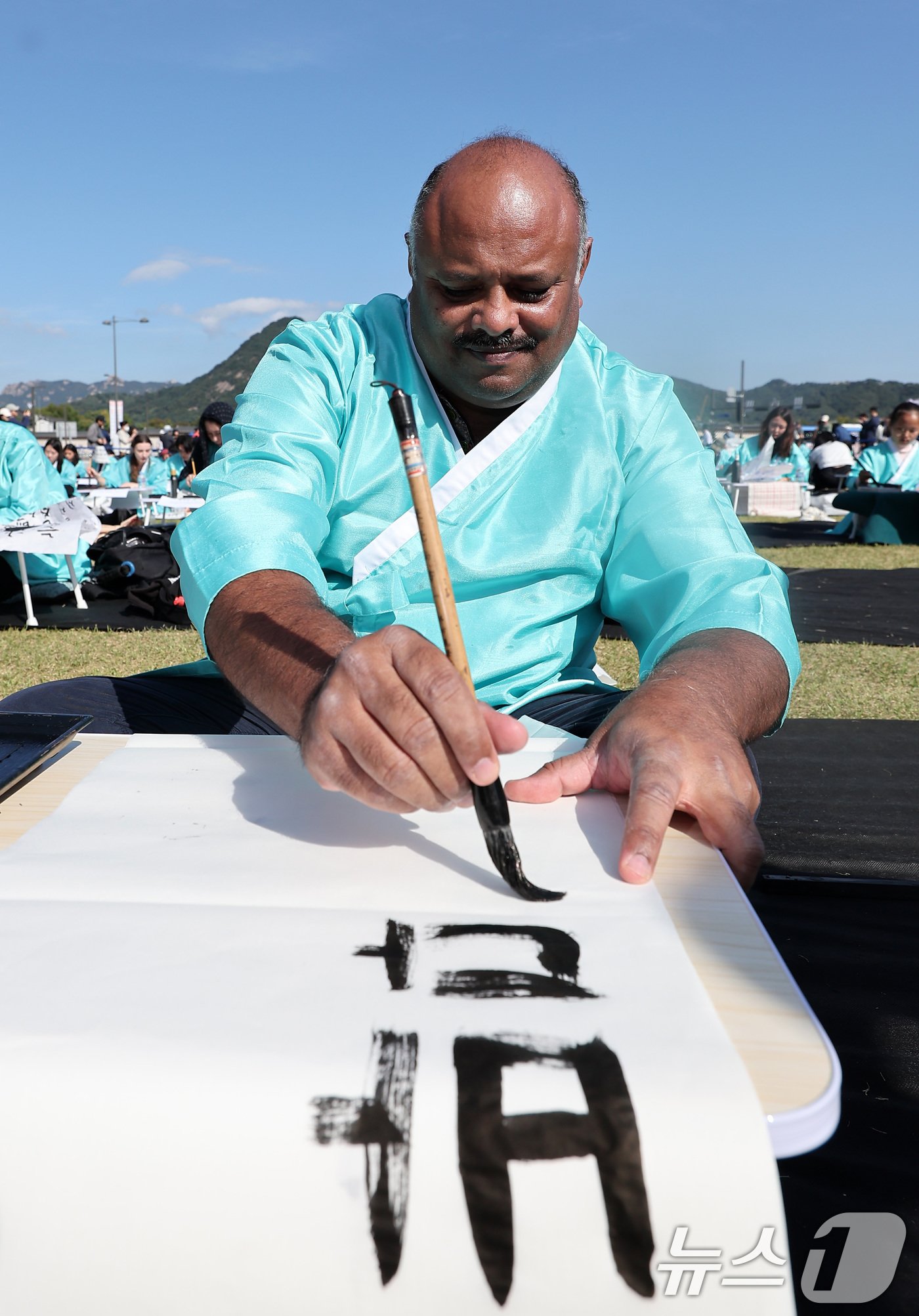 본문 이미지 - 제578돌 한글날을 맞은 9일 오전 서울 종로구 광화문광장에서 한국예술문화원 주체로 열린 조선시대 과거 시험 재현 '휘호대회'에서 외국인 참가자들이 글씨를 적고 있다. 2024.10.9/뉴스1 ⓒ News1 김성진 기자