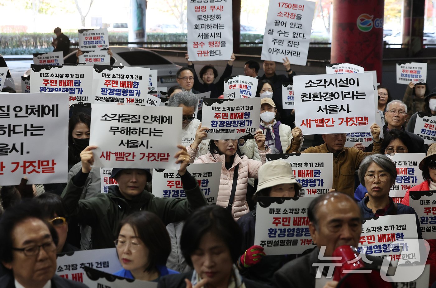 마포소각장추가백지화투쟁본부 회원들이 12일 오전 서울 마포구 월드컵경기장에서 열린 마포소각장 주민설명회에서 소각장 설치 반대 구호를 외치고 있다. 2024.11.12/뉴스1 ⓒ News1 김진환 기자