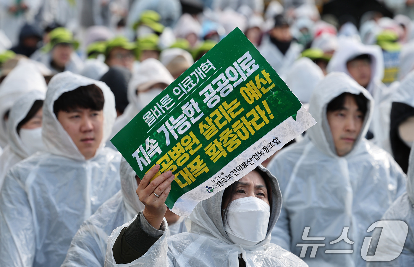 (서울=뉴스1) 김성진 기자 = 전국보건의료산업노동조합 조합원들이 26일 서울 영등포구 여의도 국회 앞에서 열린 공공병원 기능 회복‧역량 강화 촉구 결의대회에서 손피켓을 들고 있다 …