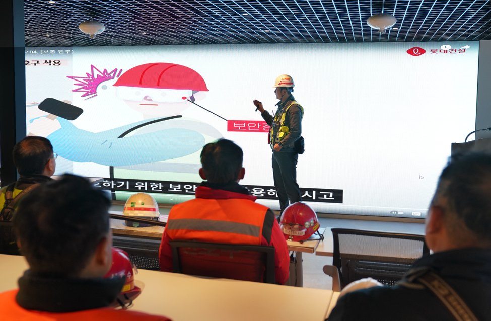 본문 이미지 - 롯데건설 현장 근로자들이 안전교육장에서 안전 수칙 애니메이션을 보고 있다. /롯데건설 제공