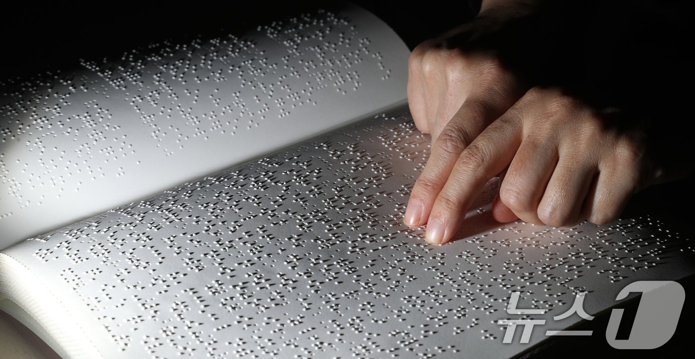 본문 이미지 - '점자의 날'인 4일 오후 경기 수원시 영통구 사랑샘도서관에서 관계자가 점자책을 읽고 있다. ‘점자의 날’은 시각장애인의 세종대왕이라 불리는 송암 박두성 선생이 시각장애인을 위한 한글 점자를 만들어 반포한 1926년 11월 4일을 기념하는 날이다. 2024.11.4/뉴스1 ⓒ News1 김영운 기자