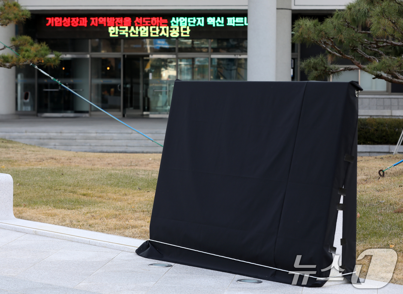 (창원=뉴스1) 윤일지 기자 = 11일 오후 경남 창원시 성산구 한국산업단지공단 경남지역본부 앞에 설치된 윤석열 대통령의 친필이 새겨진 표지석에 검은 가림막이 설치돼 있다.해당 표 …
