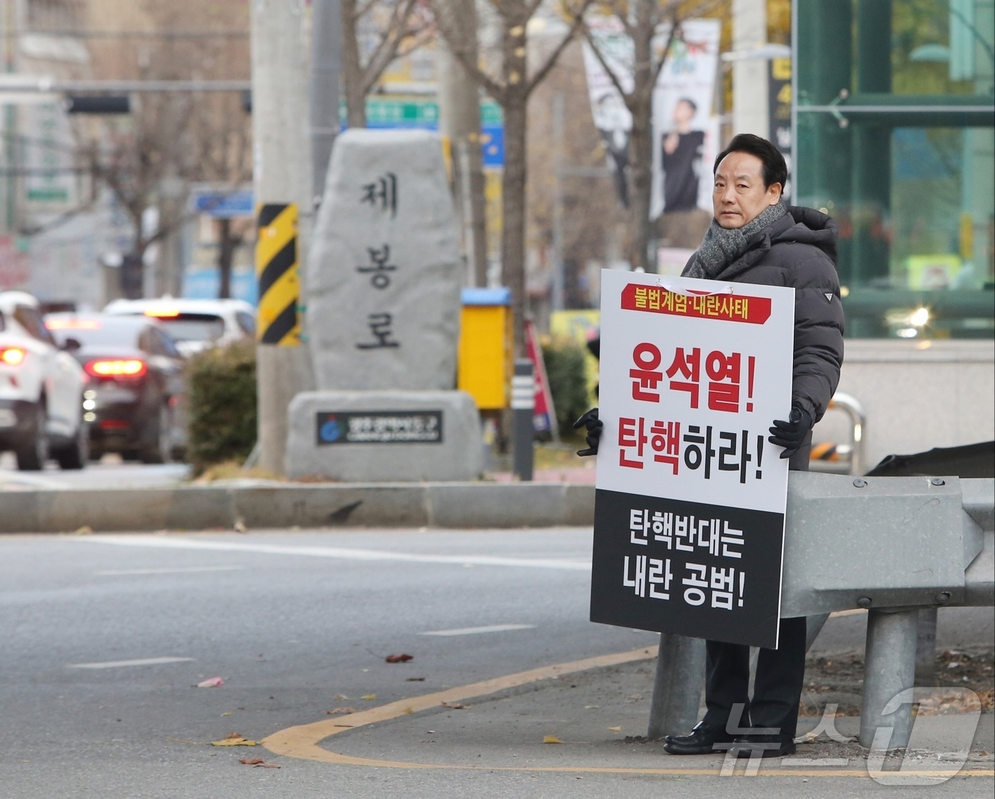 (광주=뉴스1) 이승현 기자 = 임택 광주 동구청장이 13일 오전 광주 남광주시장 인근에서 윤석열 대통령 탄핵 촉구 1인 피켓 시위를 하고 있다. (독자 제공) 2024.12.13 …