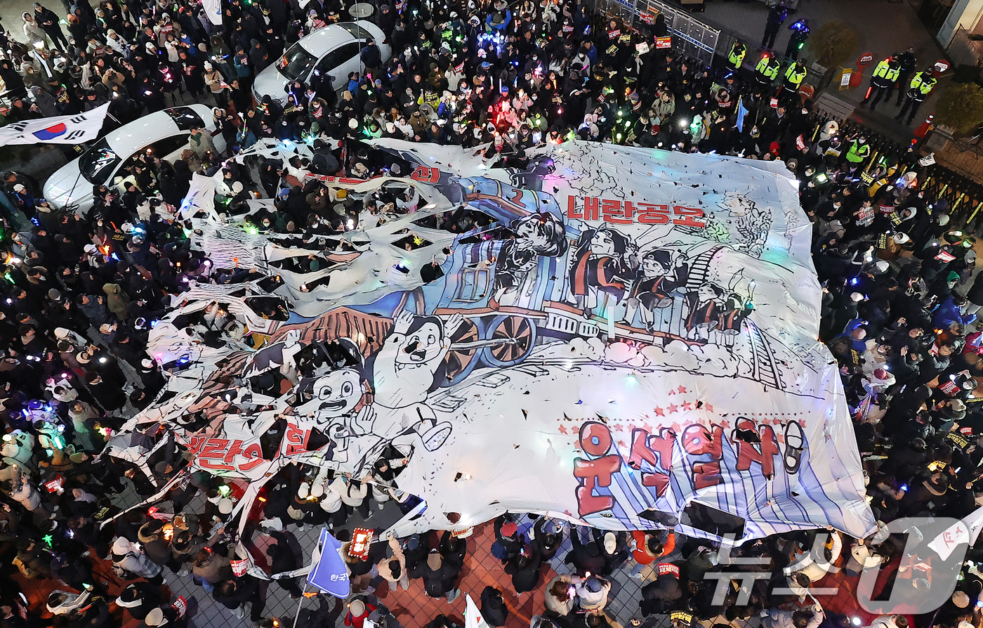 (서울=뉴스1) 김진환 기자 = 윤석열 대통령에 대한 국회의 2차 탄핵소추안 표결을 하루 앞둔 13일 오후 서울 영등포구 여의도 국민의힘 당사 앞에서 시민들이 윤석열 대통령 탄핵과 …