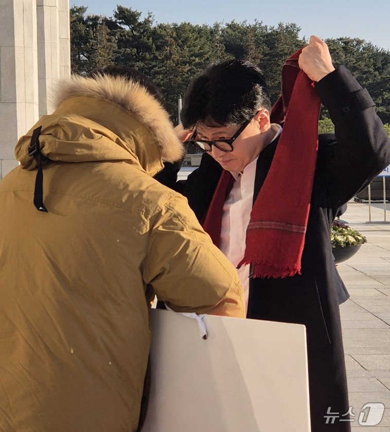 한동훈 국민의힘 대표가 14일 오전 서울 여의도 국회에서 출근하며 윤석열 대통령 탄핵 표결 찬성 1인 시위 중인 김상욱 의원에게 목도리를 둘러주고 있다. &#40;김상욱 의원실 제공&#41; 2024.12.14/뉴스1