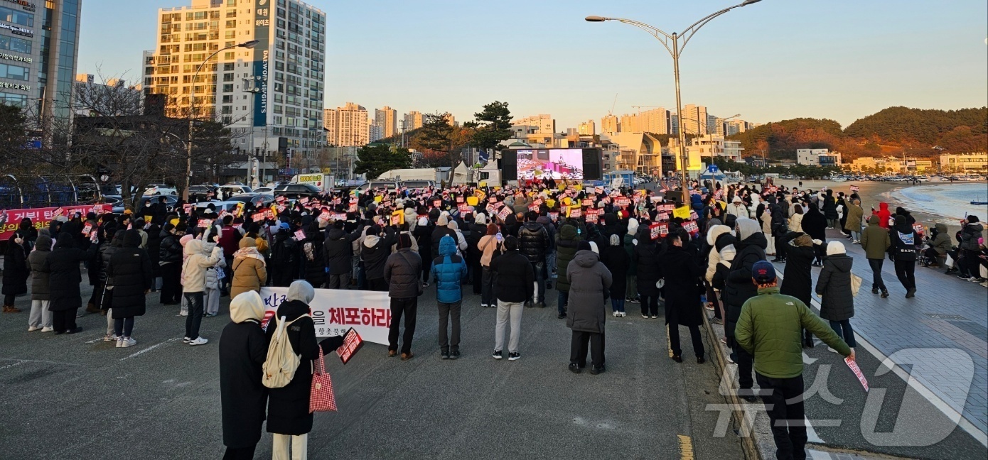 (포항=뉴스1) 최창호 기자 = 윤석열 대통령 탄핵소추안 2차 표결을 앞둔 14일 오후 경북 포항시 북구 영일대해수욕장 광장에 모인 시민들이 국회에서 진행  중인 투표 상황을 지켜 …