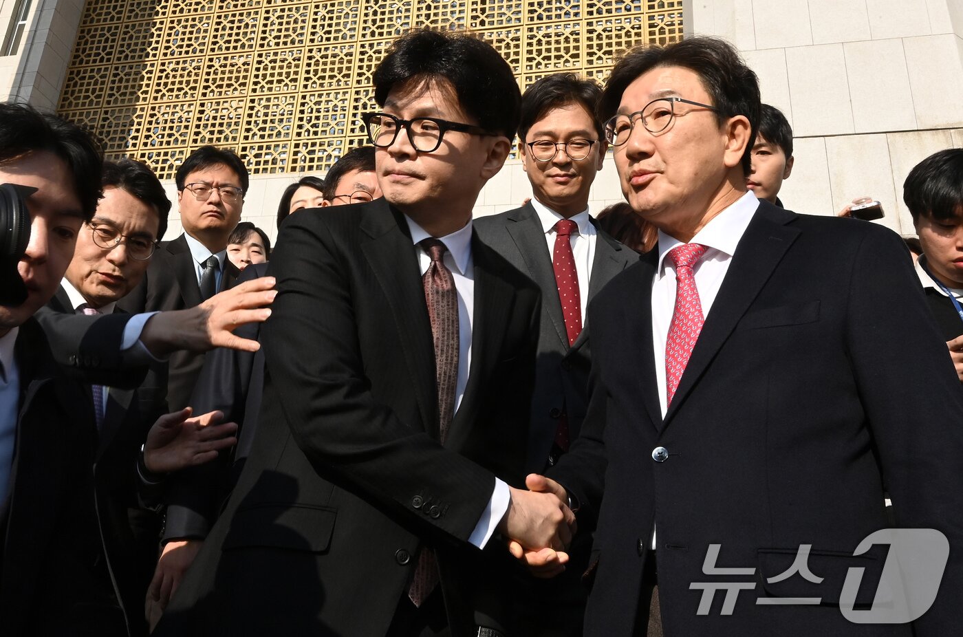 본문 이미지 - 한동훈 국민의힘 대표가 16일 오전 서울 여의도 국회에서 당대표직 사퇴 기자회견을 마친 뒤 국회를 떠나며 권성동 원내대표와 악수하고 있다. &#40;공동취재&#41; 2024,12,16/뉴스1 ⓒ News1 안은나 기자