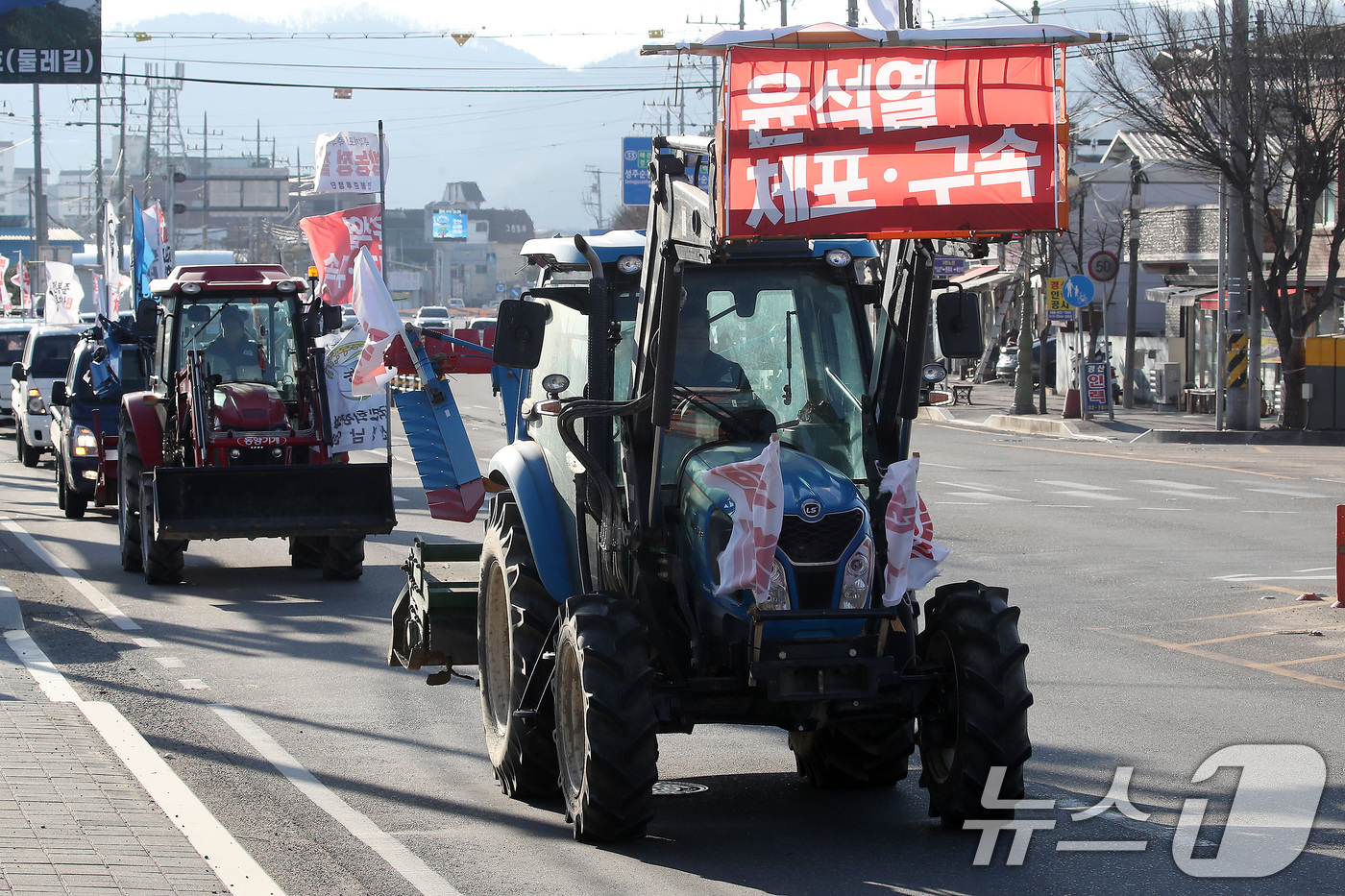 (성주=뉴스1) 공정식 기자 = '세상을 바꾸는 전봉준투쟁단 트랙터 경북 대행진'에 참여한 경북지역 농민들이 18일 오전 경북 성주군청 앞에서 윤석열 대통령의 체포와 구속을 촉구하 …