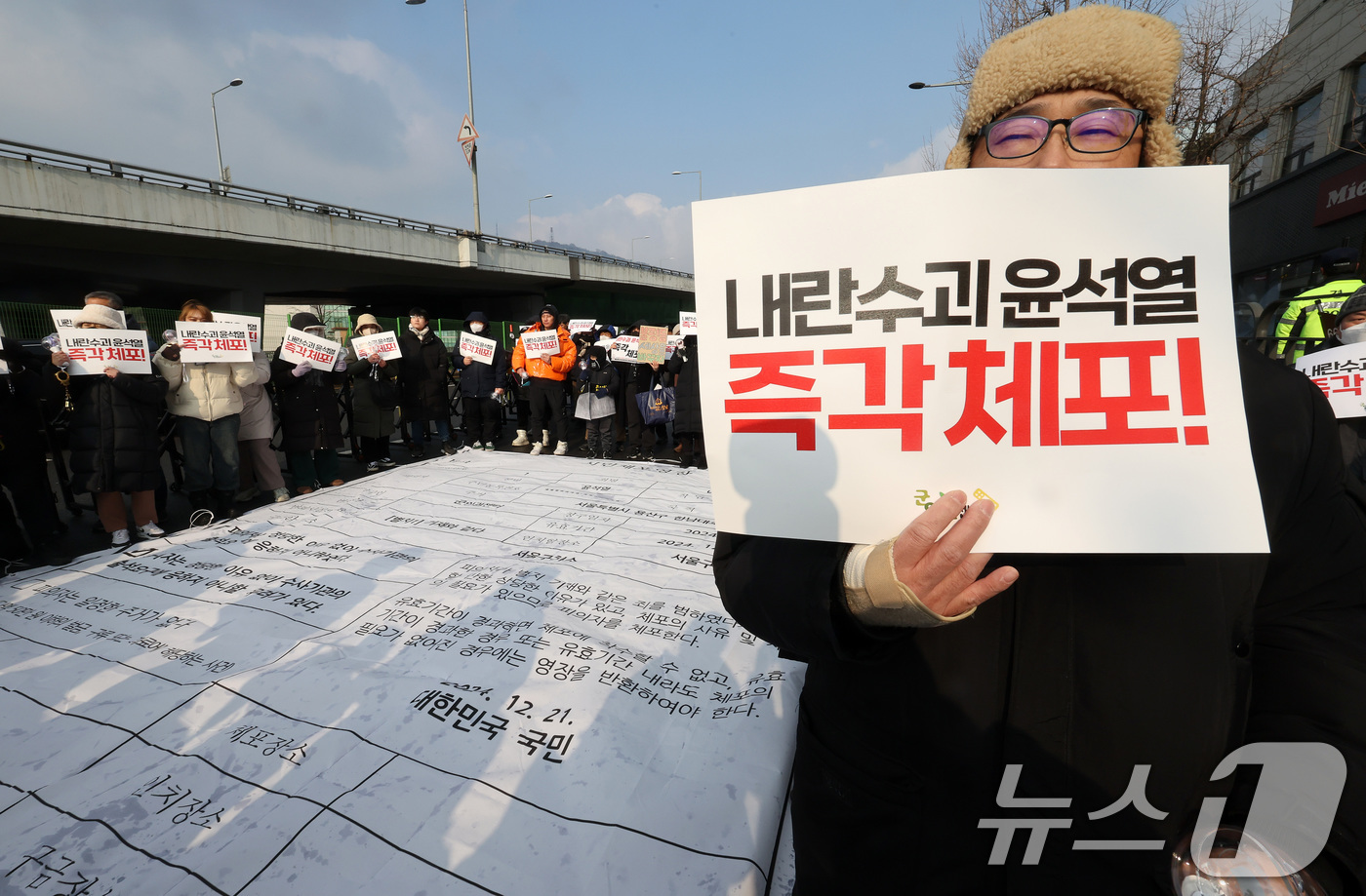 (서울=뉴스1) 이동해 기자 = 군인권센터와 민주사회를위한변호사모임 공익인권변론센터 관계자들이 21일 오전 서울 용산구 한남동 대통령 관저 인근에서 '윤석열 대통령 시민체포영장 집 …