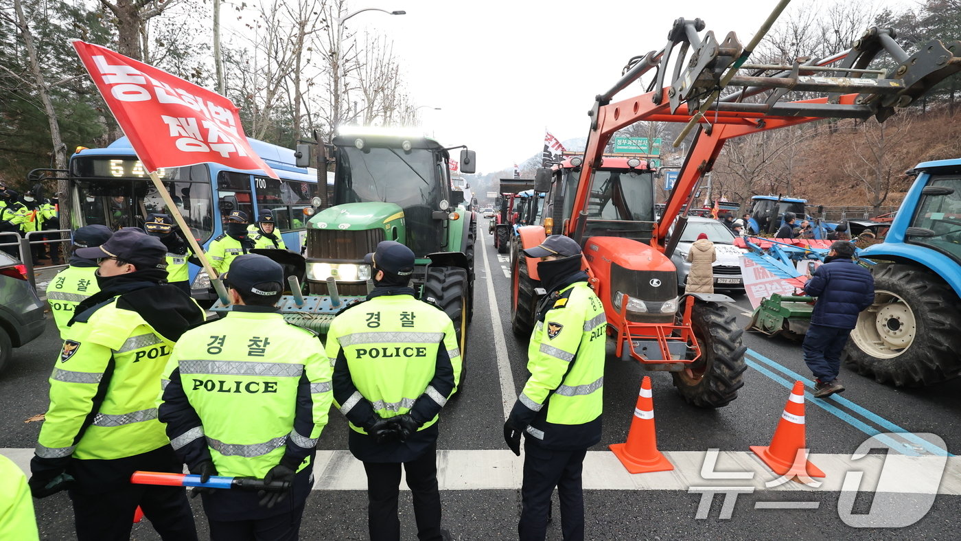 본문 이미지 - 전국농민회총연맹 전봉준 투쟁단 농민들이 21일 윤석열 대통령 구속 등을 촉구하는 집회를 위해 트랙터와 트럭을 몰고 상경하던 중 서울 남태령 고개 인근에서 경찰병력과 대치하고 있다. 2024.12.21/뉴스1 ⓒ News1 이동해 기자