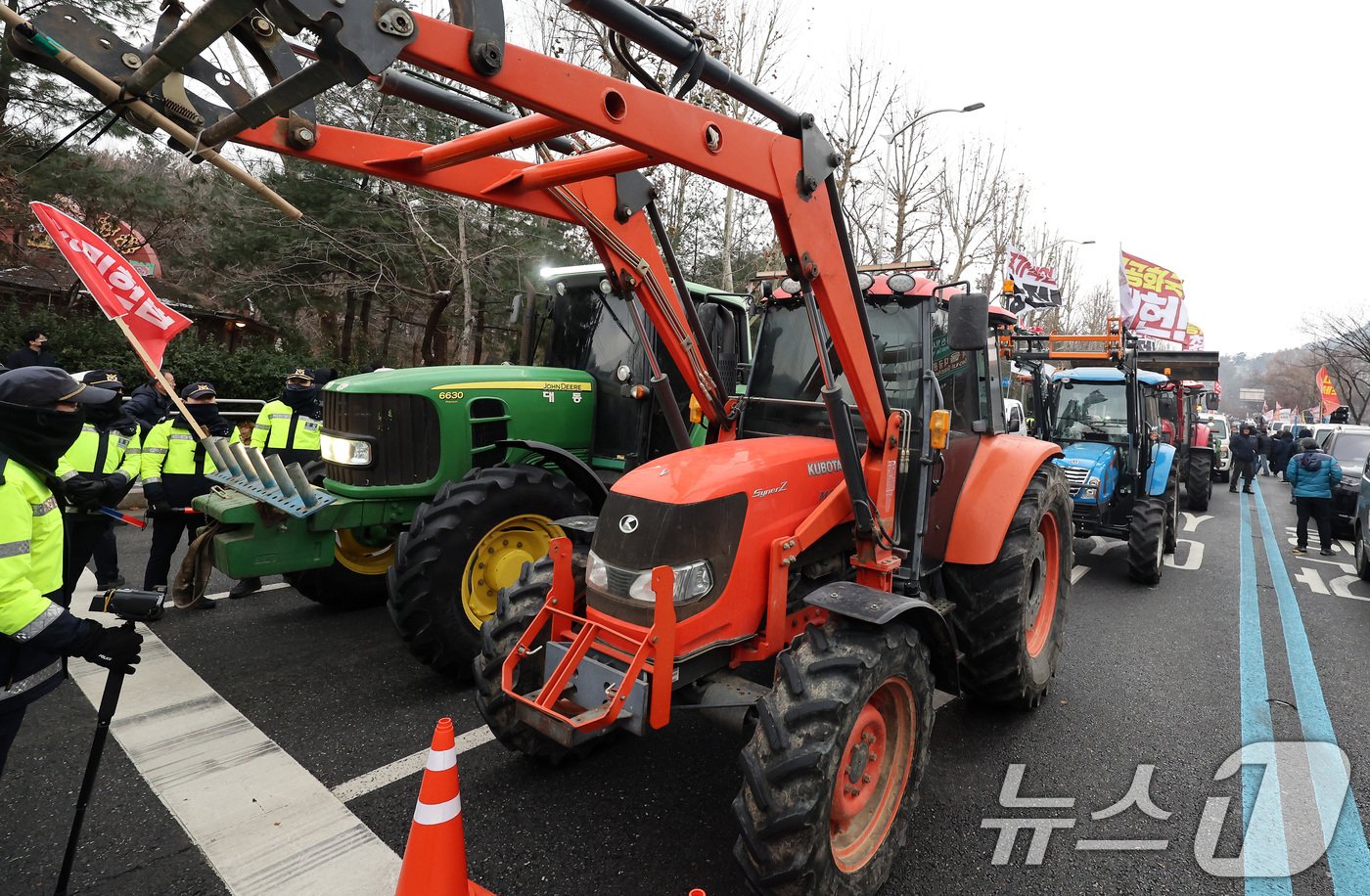 본문 이미지 - 전국농민회총연맹 전봉준 투쟁단 농민들이 21일 윤석열 대통령 구속 등을 촉구하는 집회를 위해 트랙터와 트럭을 몰고 상경하던 중 서울 남태령 고개 인근에서 경찰병력과 대치하고 있다. 2024.12.21/뉴스1 ⓒ News1 이동해 기자
