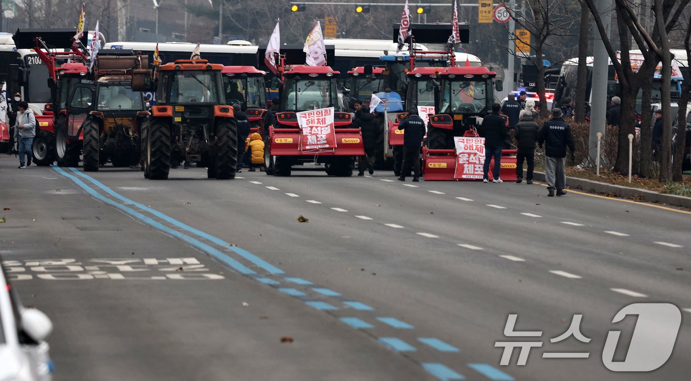 본문 이미지 - 전국농민회총연맹 전봉준 투쟁단 농민들이 21일 윤석열 대통령 구속 등을 촉구하는 집회를 위해 트랙터와 트럭을 몰고 상경하던 중 서울 남태령 고개 인근에서 경찰병력과 대치하고 있다. 2024.12.21/뉴스1 ⓒ News1 이동해 기자
