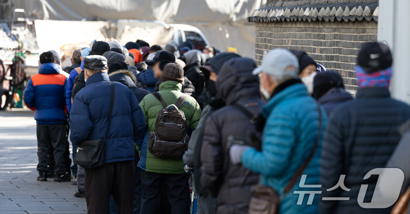 (서울=뉴스1) 이승배 기자 = 아침 기온이 큰 폭으로 떨어지며 추운 날씨를 보인 22일 오전 서울 종로구 탑골공원 원각사 노인 무료급식소를 찾은 어르신들이 식사를 위해 줄 서 있 …