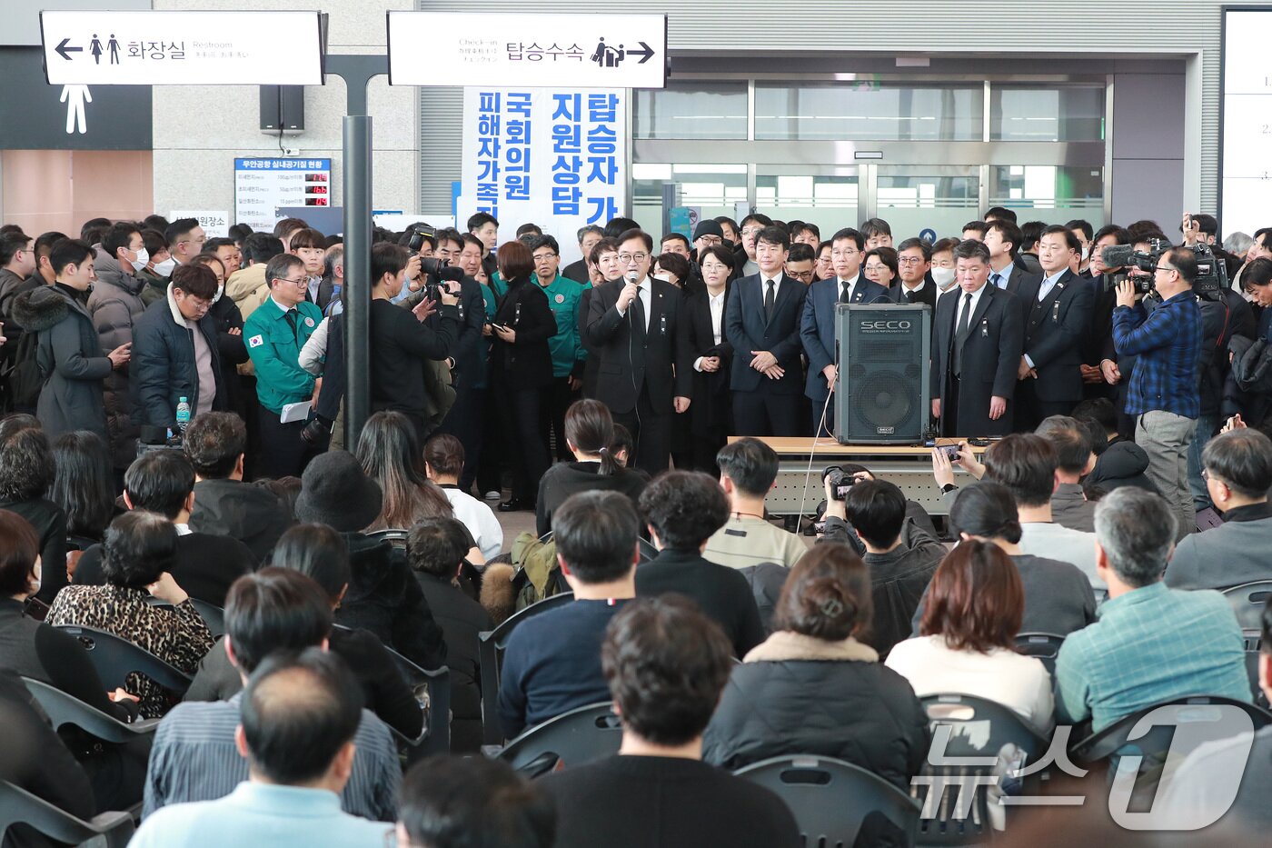 본문 이미지 - 30일 오후 무안국제공항에서 대기하는 제주항공 여객기 사고 탑승객 유가족. (공동취재) /뉴스1 ⓒ News1 김성진 기자