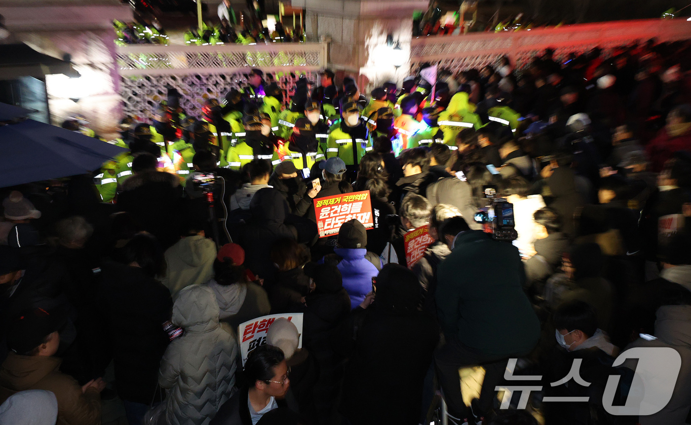 (서울=뉴스1) 장수영 기자 = 윤석열 대통령의 비상계엄 해제 요구 결의안이 국회 본회의에서 통과된 4일 새벽 서울 여의도 국회 정문 앞에 모인 시민들이 윤 대통령을 규탄하고 있다 …