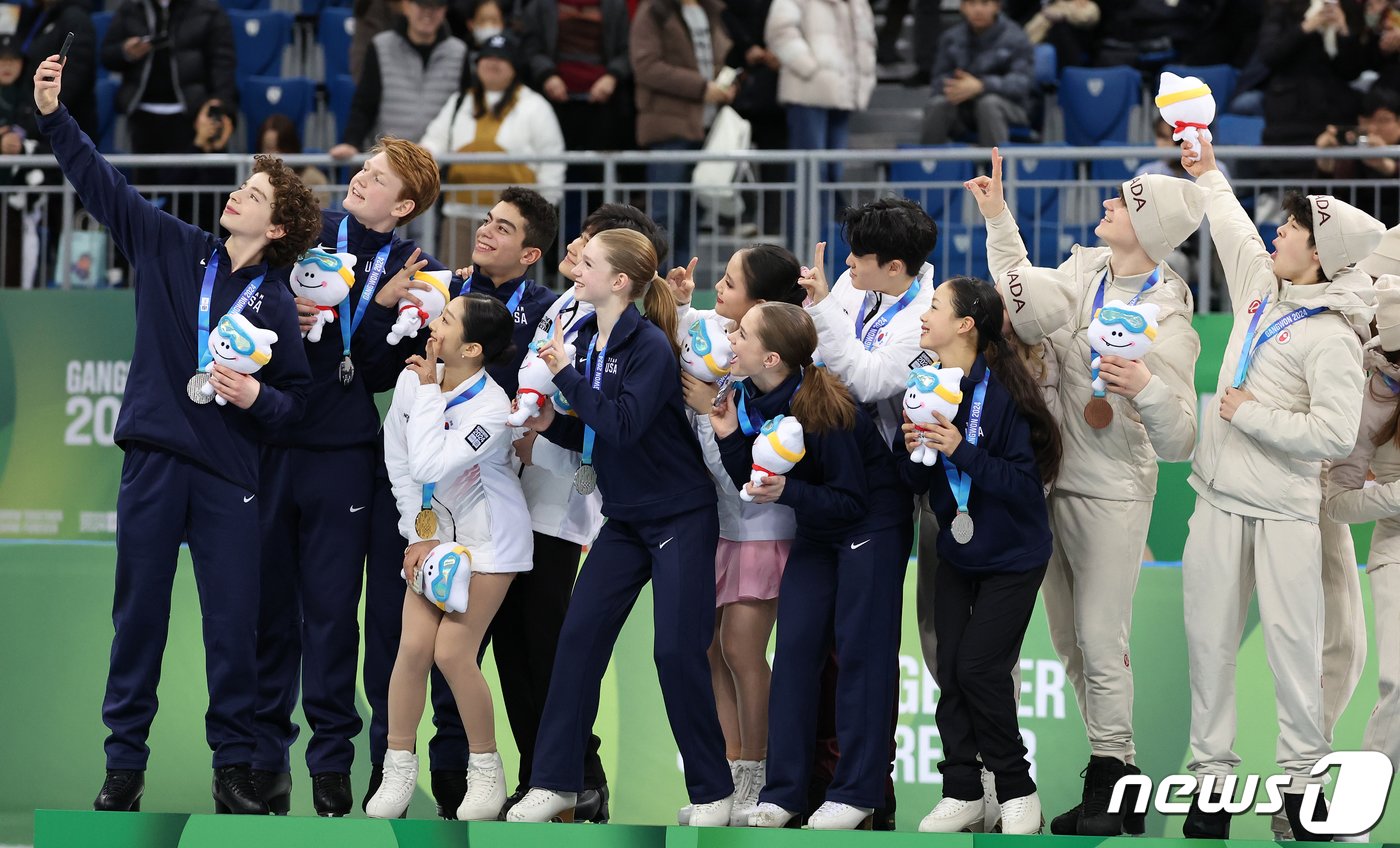 2024 강원동계청소년올림픽 피겨 스케이팅 단체전에서 금메달을 차지한 대한민국 피겨 신지아, 김현겸, 김지니. 이나무가 1일 오후 강원 강릉 올림픽파크 강릉아이스아레나에서 시상식을 마친 뒤 은메달을 획득한 미국, 동메달을 획득한 캐나다 선수들과 함께 셀피를 찍고 있다. 2024.2.1/뉴스1 ⓒ News1 김진환 기자