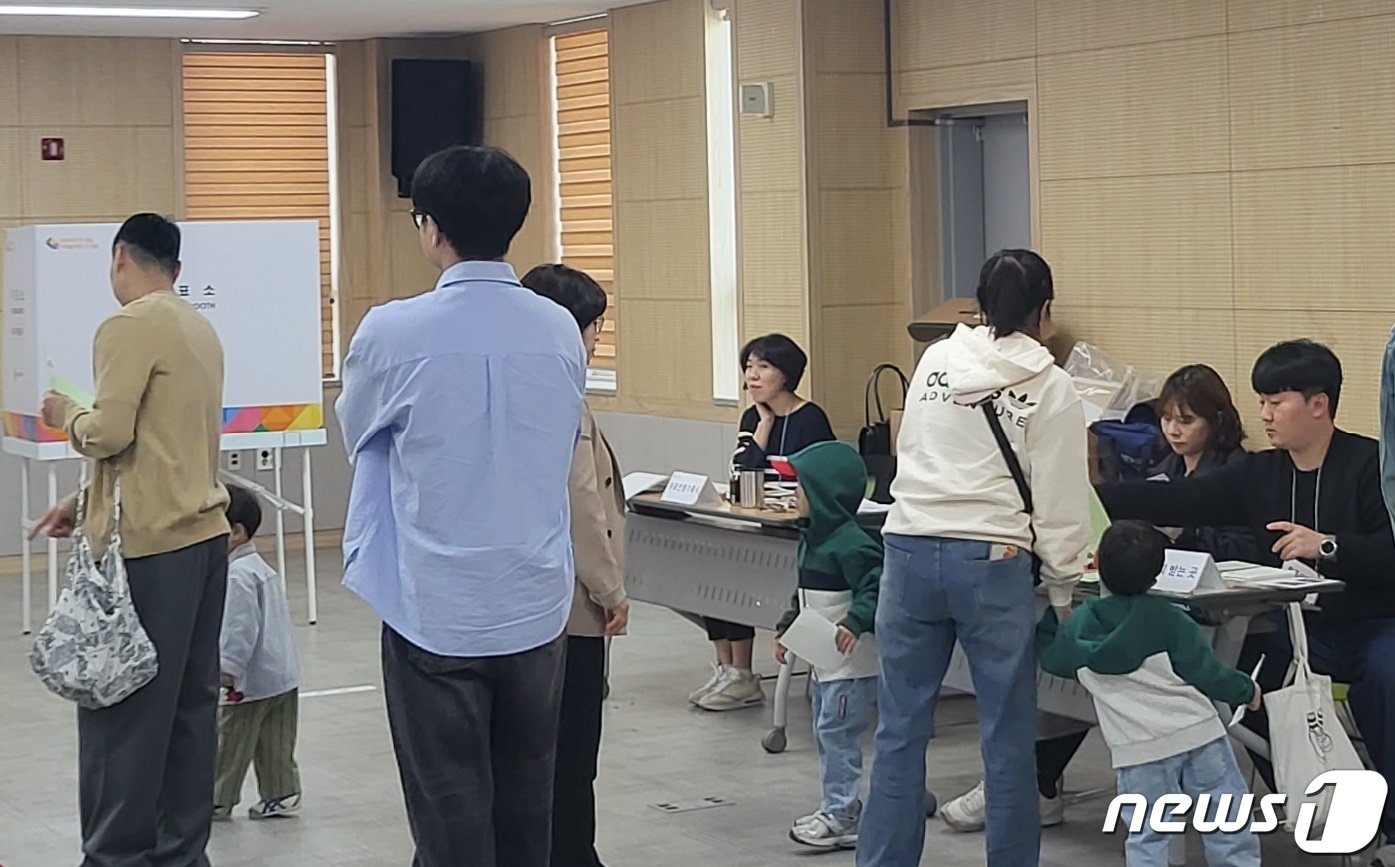 본문 이미지 - 제22대 국회의원선거 본 투표일인 10일 오전 강원 원주시 반곡관설동 행정복지센터에 어린이의 손을 잡은 유권자가 투표 절차에 나서고 있다. 2024.4.10/뉴스1 신관호 기자