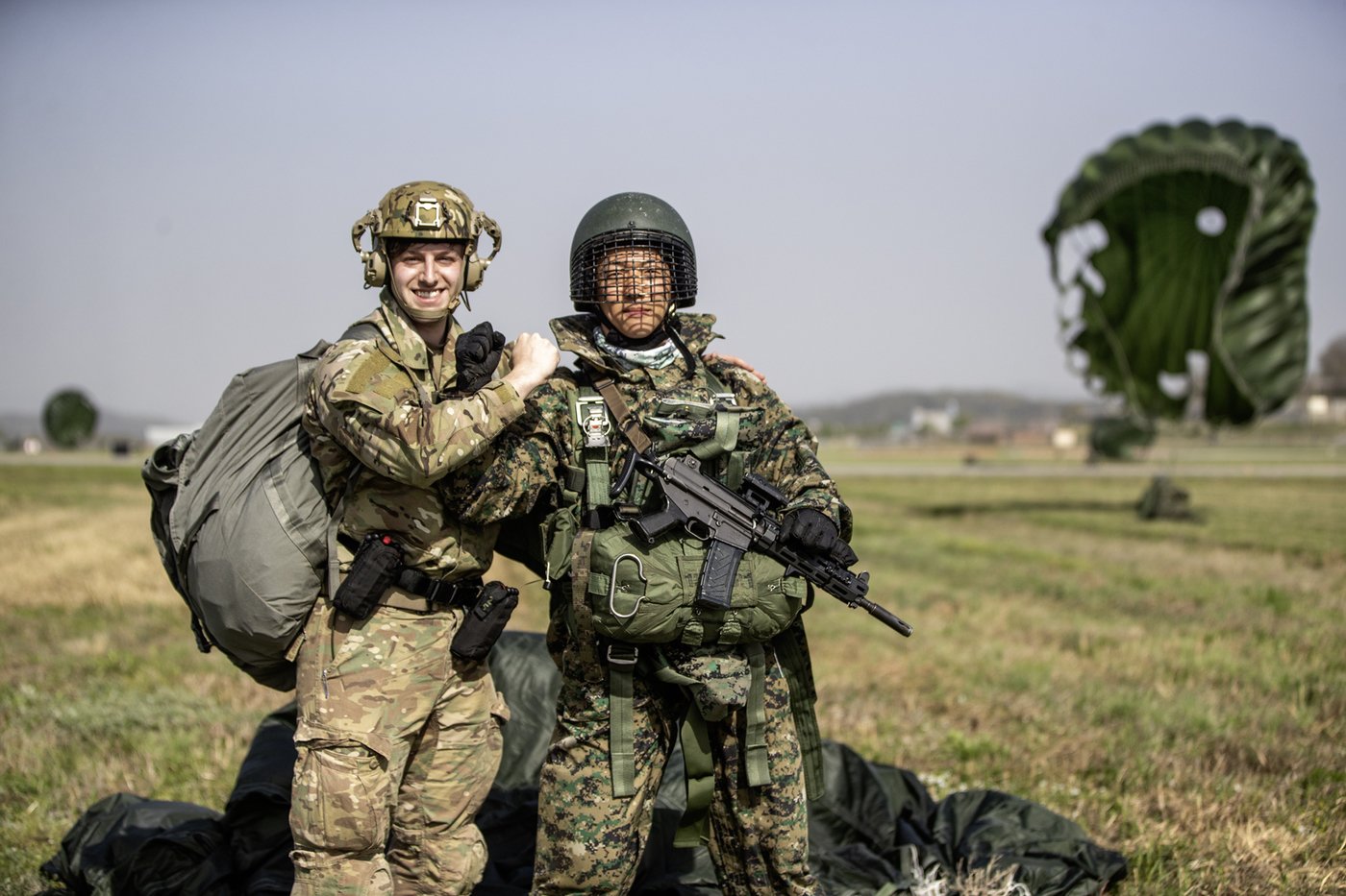 본문 이미지 - 지난 18일 연합공중침투훈련 중 한미 특전대원들이 강하를 성공적으로 마친 후 서로를 격려하고 있다.(육군 제공)