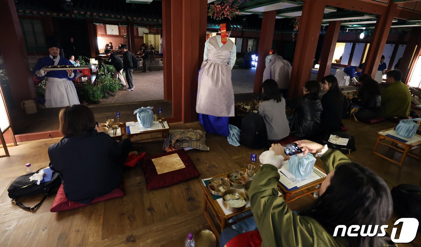 본문 이미지 - 2일 오후 서울 경복궁에서 열린 경복궁 별빛야행 사전행사에서 참가자들이 소주방 '도슭수라상'을 체험하고 있다. '경복궁 별빛야행'은 오는 3일부터 5월4일까지 하루 2회씩 운영한다. 2024.4.2/뉴스1 ⓒ News1 이동해 기자