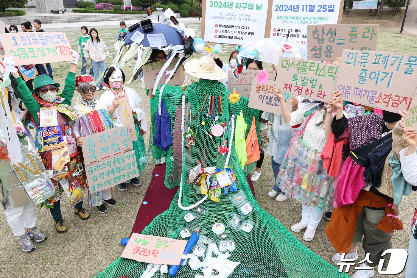 본문 이미지 - 지구의 날을 맞은 22일 오전 서울 중구 남산둘레길에서 소비자기후행동 관계자들이 폐플라스틱과 버려진 의류를 활용한 '플라스틱 패션쇼'를 마친 뒤 기념촬영을 하고 있다. 지구의 날은 1969년 1월28일 미국 캘리포니아 산타바바라 해협에서 발생한 해상 기름 유출사고를 계기로 제정됐다. 2024.4.22/뉴스1 ⓒ News1 민경석 기자
