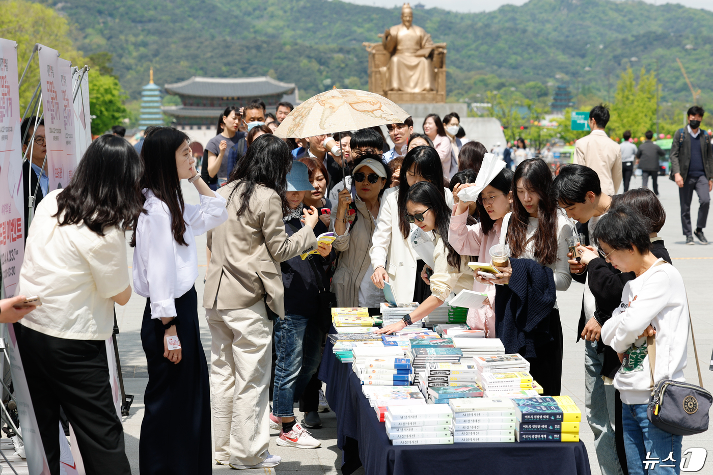 (서울=뉴스1) 안은나 기자 = 세계 책의 날인 23일 서울 종로구 광화문 광장 해치마당에서 문화체육관광부 '더 많은 책, 더 넓은 세계' 행사에 참여한 시민들이 책나눔을 받고 있 …