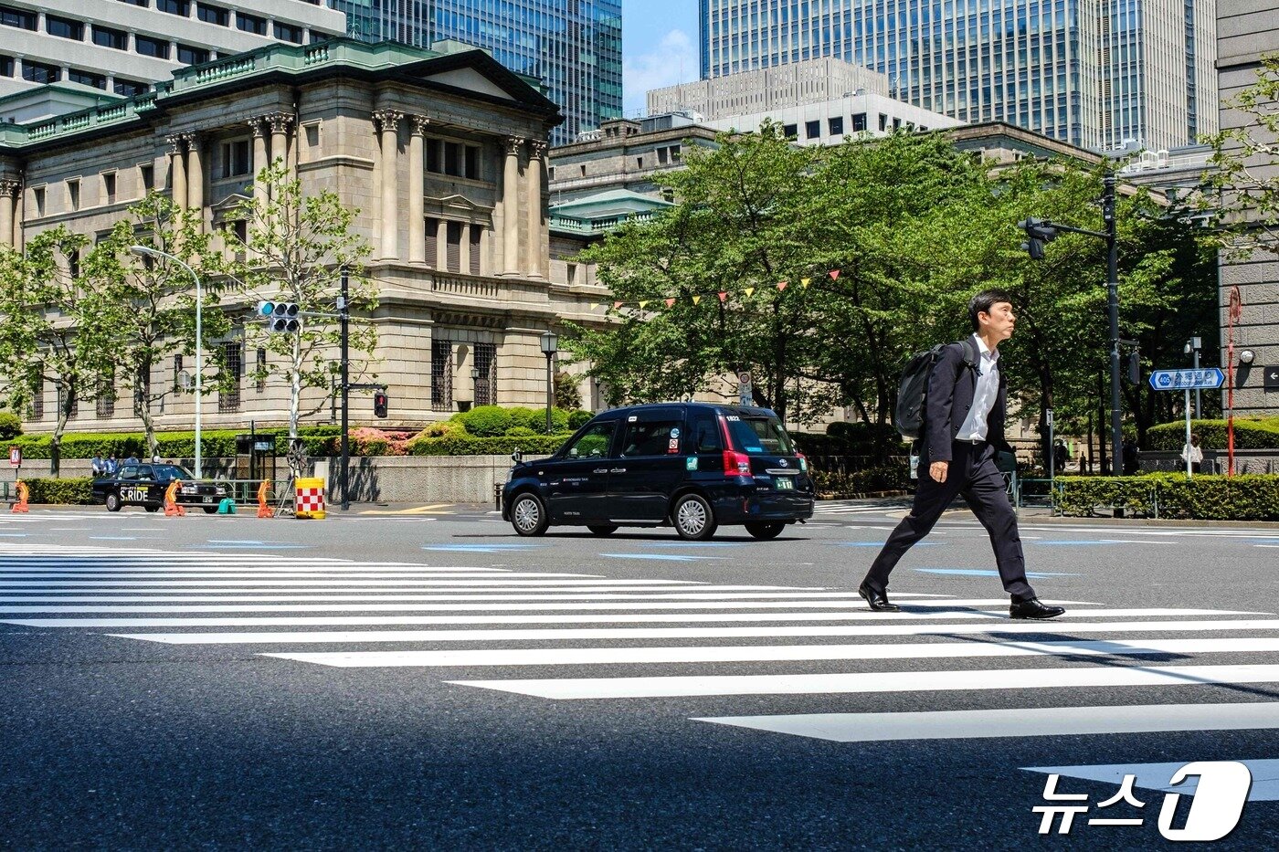 25働いた東京市民が中央銀行である日銀(BoJ)前横断歩道を渡っている. この日円為替がドル当り 155円を突破するによって BoJが介入に出るか注目される. 2024.04.25 c。 AFP=ニュース1 c。 News1 止まりつや者 