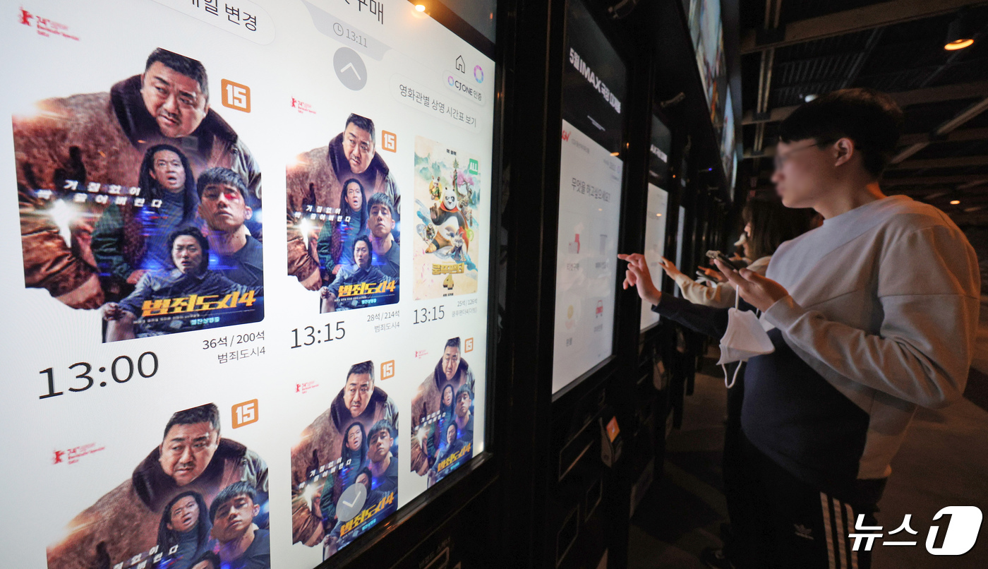 (서울=뉴스1) 장수영 기자 = 28일 오후 서울 용산구 CGV를 찾은 영화관람객들이 범죄도시4 티켓을 구매하고 있다.범죄도시4는 개봉 나흘째를 맞아 누적관객 300만명을 돌파했다 …