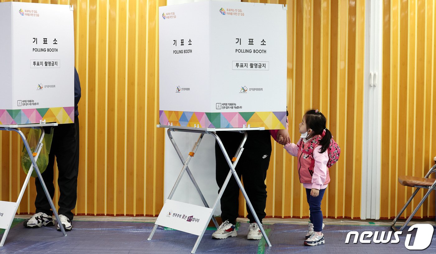 본문 이미지 - 제22대 국회의원선거 사전투표일 첫날인 5일 서울의 한 사전투표소에서 어린이가 투표하는 엄마를 지켜보고 있다. 2024.4.5/뉴스1 ⓒ News1 박지혜 기자