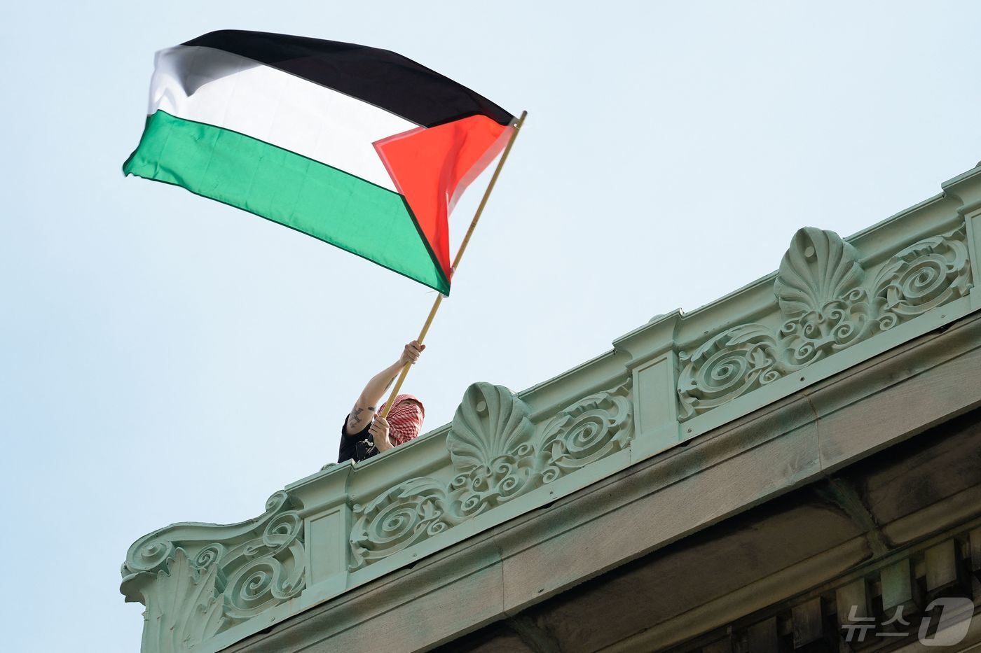 본문 이미지 - 친팔레스타인 시위대원이 뉴욕 컬럼비아대 해밀턴 홀 옥상에 올라 팔레스타인 깃발을 흔들며 해산에 나선 당국에 항의하고 있다. 뉴욕경찰은 30일(현지간) 늦은 밤 교내에 진입 해밀턴 홀 주변 농성중이던 시위대 수십명을 연행해 갔다, 2024.05.01 ⓒ AFP=뉴스1 ⓒ News1 정지윤기자