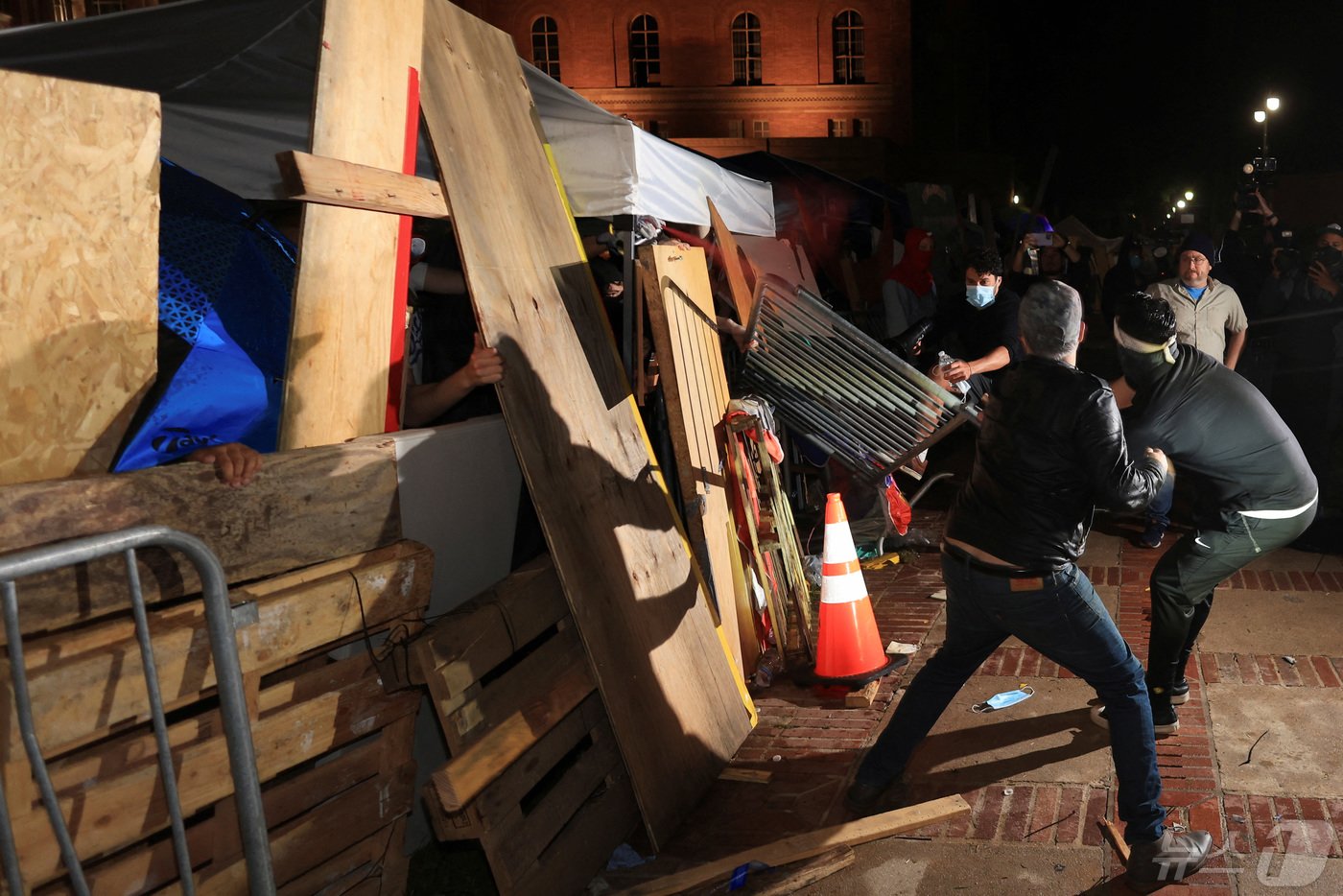 본문 이미지 - 미국 캘리포니아주 로스앤젤레스에서 친이스라엘 시위대가 로스앤젤레스 캘리포니아 대학교(UCLA) 캠퍼스 내 친팔레스타인 시위대의 바리케이드를 공격하고 있다. ⓒ 로이터=뉴스1 ⓒ News1 김현 특파원