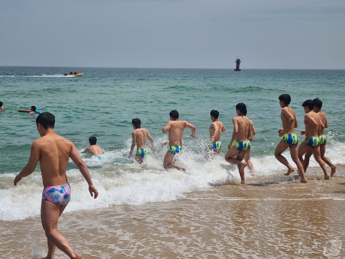 본문 이미지 - 12일 강원 강릉시 경포해변을 찾은 수상안전요원들이 훈련을 위해 바다에 입수하고 있다. 2024.5.12/뉴스1 ⓒ News1 윤왕근 기자