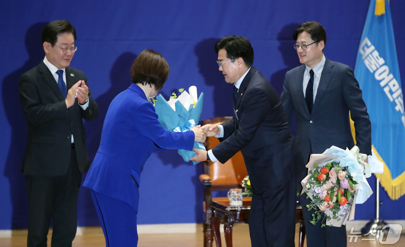 박찬대 신임 원내대표가 3일 오전 서울 여의도 국회 의원회관에서 열린 &#39;제22대 국회 더불어민주당 제1기 원내대표 선출 당선자 총회&#39;에서 진선미 선거관리위원장으로부터 꽃다발을 받고 있다. 2024.5.3/뉴스1 ⓒ News1 임세영 기자