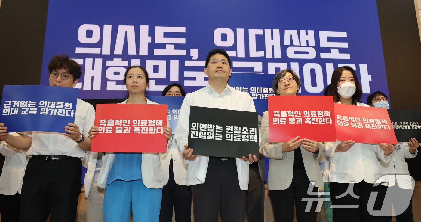 본문 이미지 - 서울대학교 의과대학 교수, 전공의, 의대생들이 17일 오전 서울 종로구 서울대학교 의과대학 융합관 양윤선홀에서 열린 휴진 결의 집회에서 손펫말을 들고 있다. .2024.6.17/뉴스1 ⓒ News1 박지혜 기자