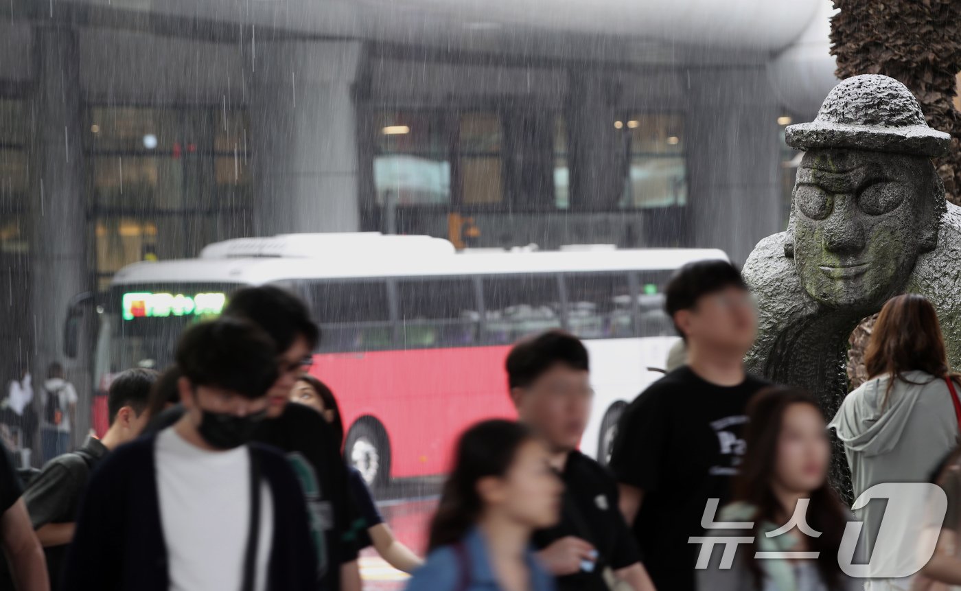 본문 이미지 - 제주에 올해 첫 장맛비가 내린 20일 오전 제주국제공항에서 관광객들이 비를 피해 빠르게 이동하고 있다. 2024.6.20/뉴스1 ⓒ News1 오현지 기자
