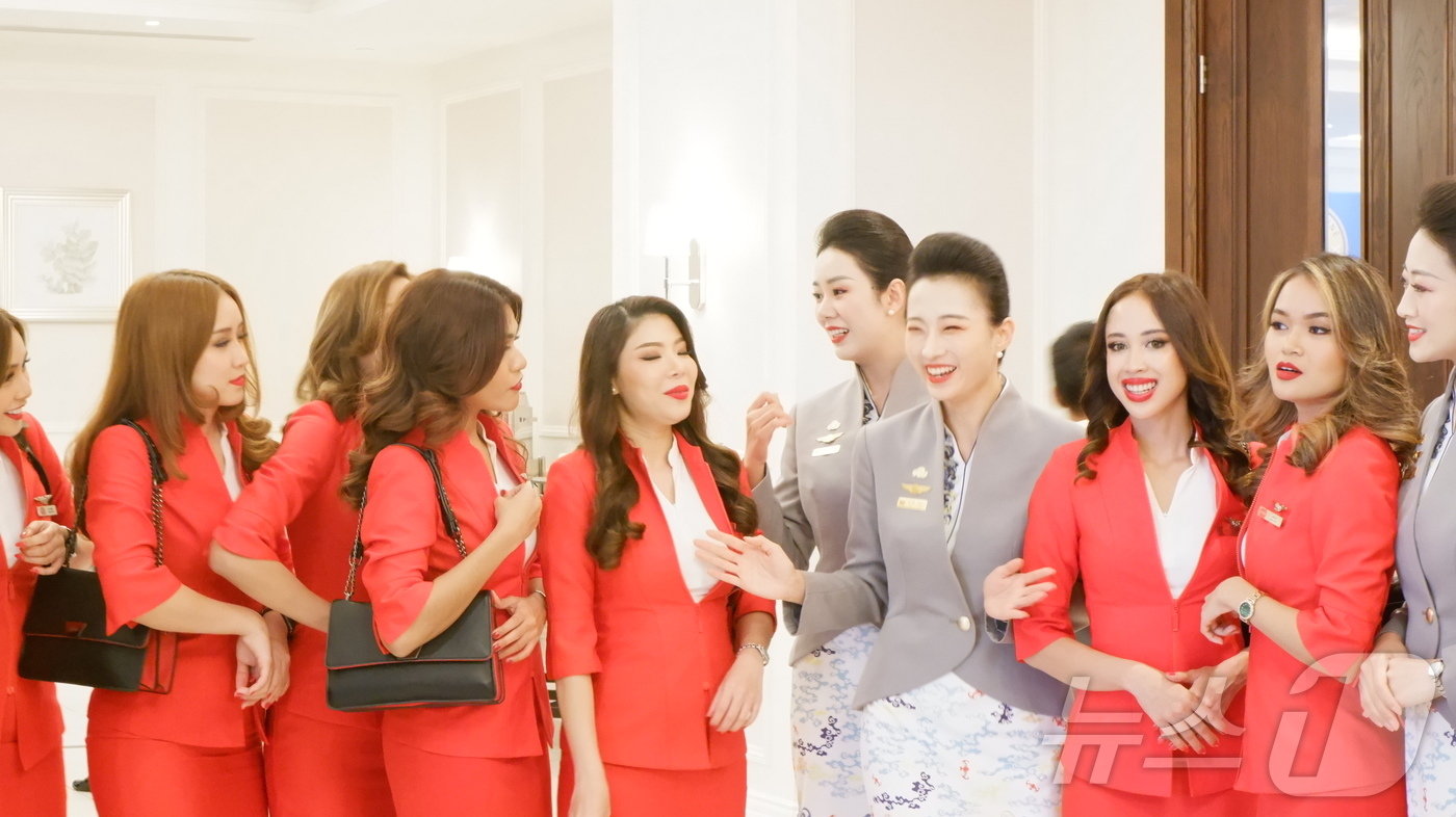 본문 이미지 - 말레이시아 국적 에어아시아 승무원과 중국 국적 하이난항공 승무원들이 교류하고 있다ⓒ News1 윤슬빈 기자