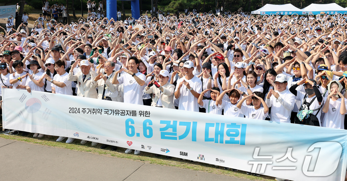 (서울=뉴스1) 이동해 기자 = 현충일인 6일 서울 중구 백범광장공원에서 '주거취약 국가유공자 주거 지원 사업' 모금을 위해 진행된 6.6 걷기대회에서 오세훈 서울시장과 참전용사, …