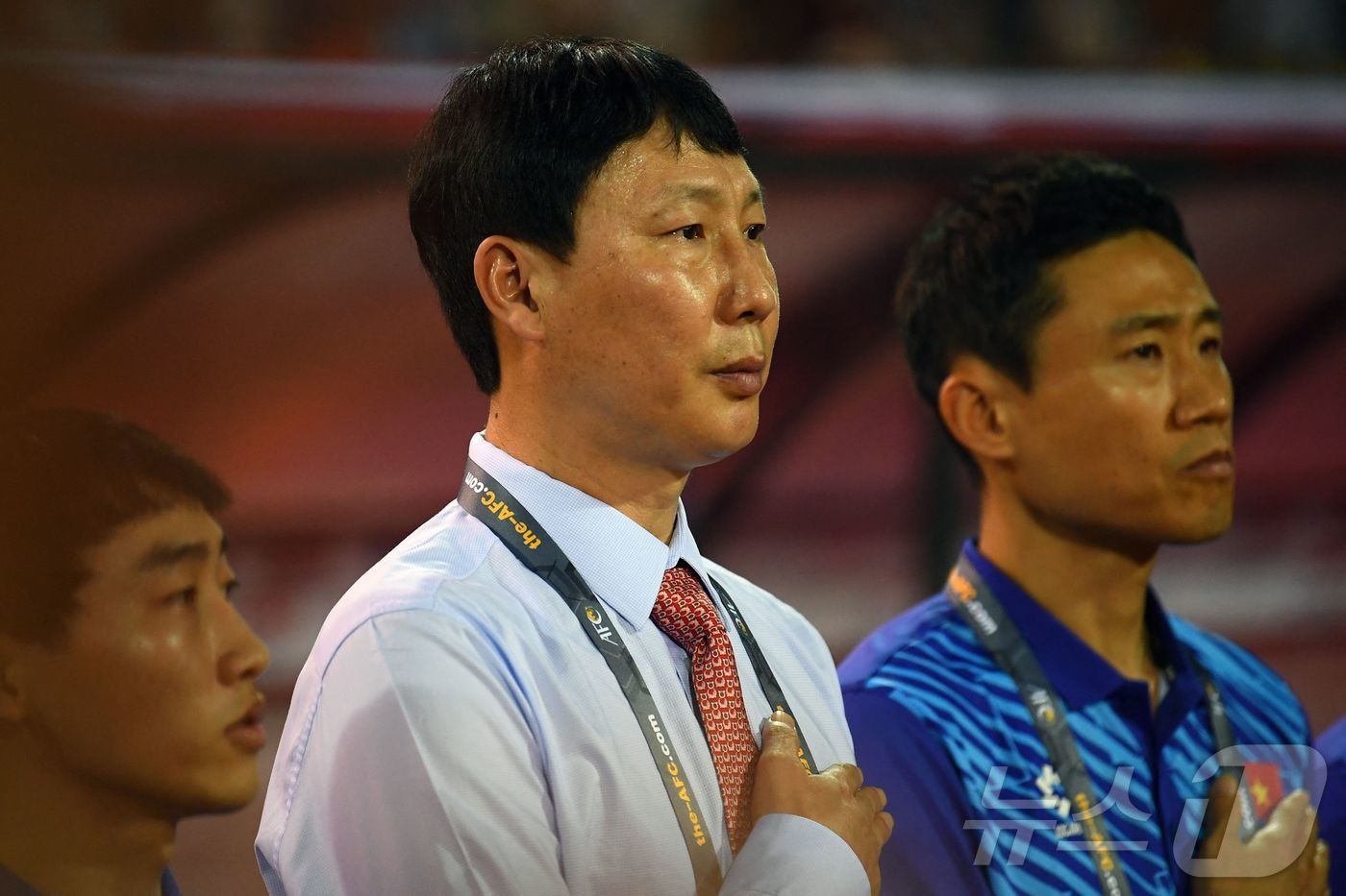 Vietnam's coach Kim Sang-sik (C) listens to the national anthem before the 2026 FIFA World Cup AFC q …