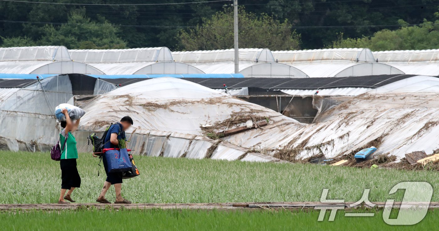 본문 이미지 - 어제 내린 집중호우로 마을 전체가 침수 피해를 입은 대전 서구 용촌동에서 11일 주민들이 짐을 챙겨 이동하고 있다. 2024.7.11/뉴스1 ⓒ News1 김기태 기자